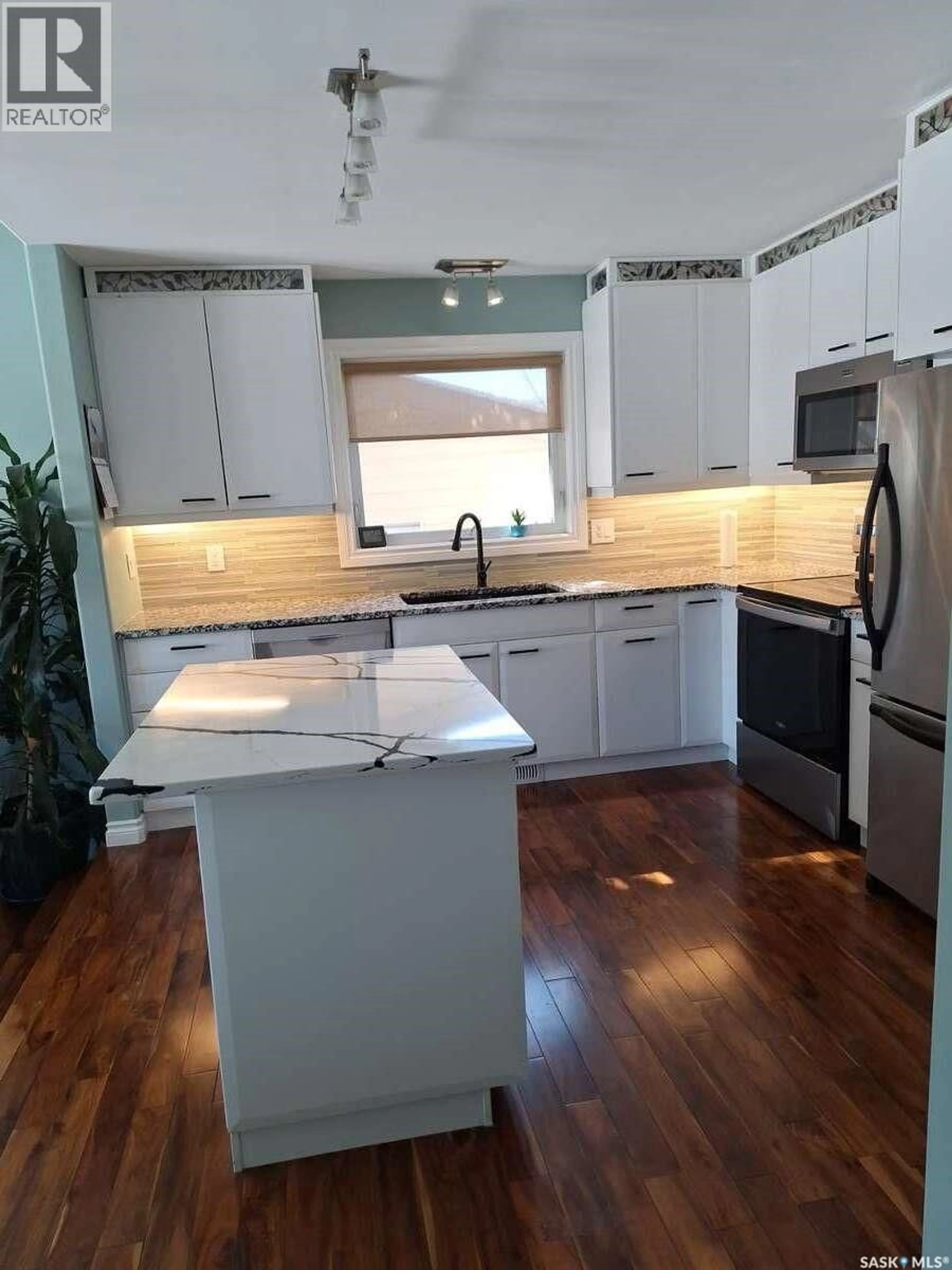 Open concept kitchen, wood/laminate floor for 819 MORRIS CRESCENT, Regina Saskatchewan S4X2L6