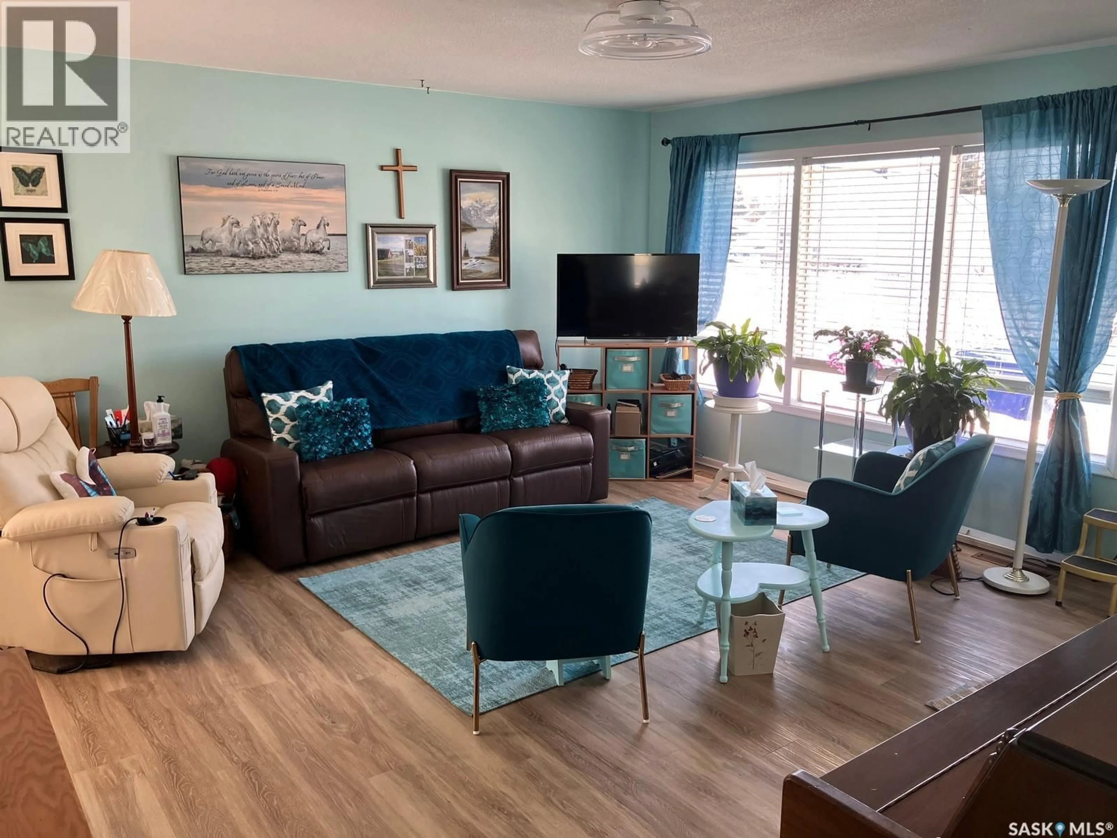 Living room with furniture, wood/laminate floor for 311 1ST STREET, Nipawin Saskatchewan S0E1E0