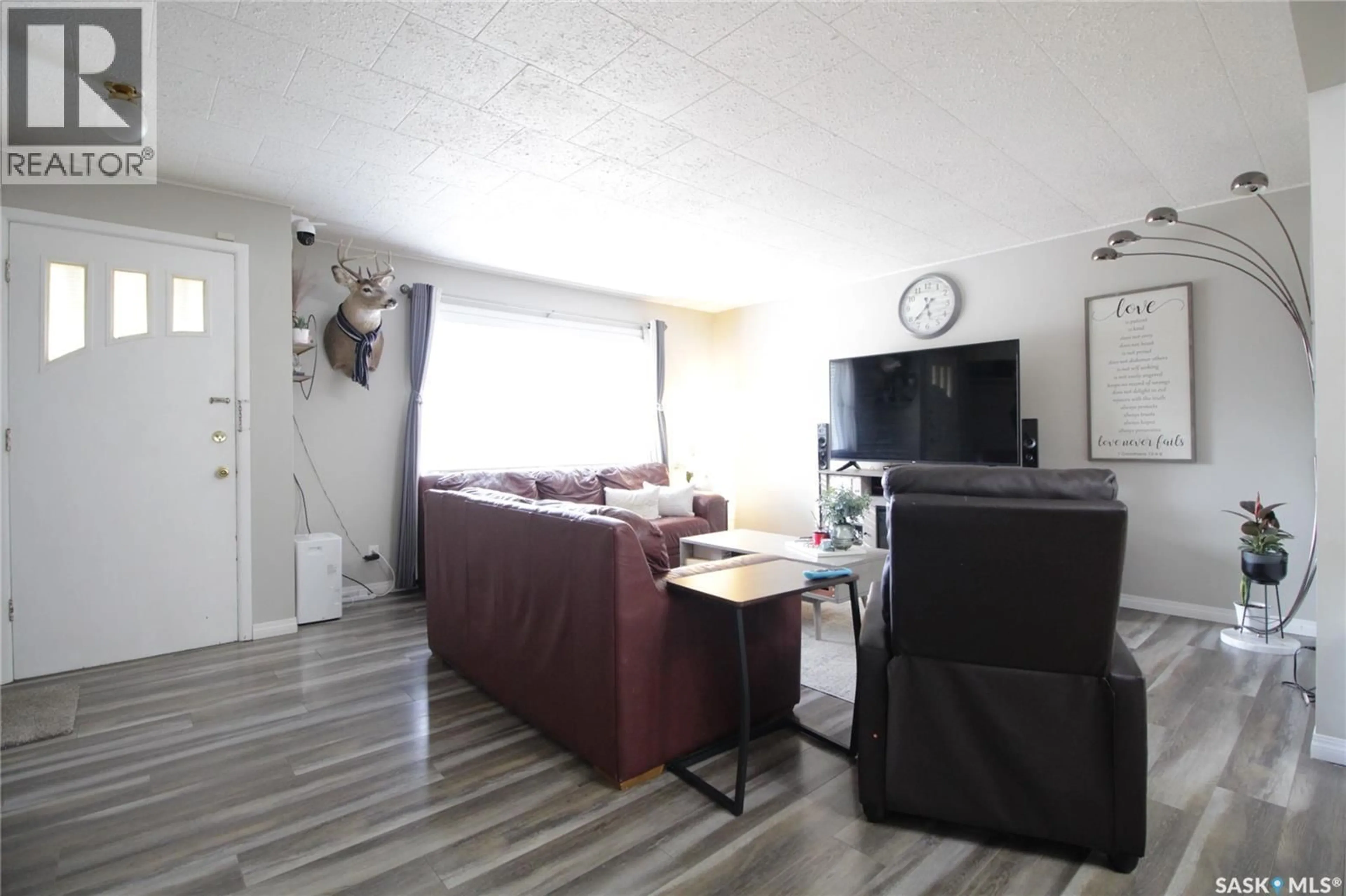 Living room with furniture, wood/laminate floor for 1101 GORDON STREET, Moosomin Saskatchewan S0G3N0