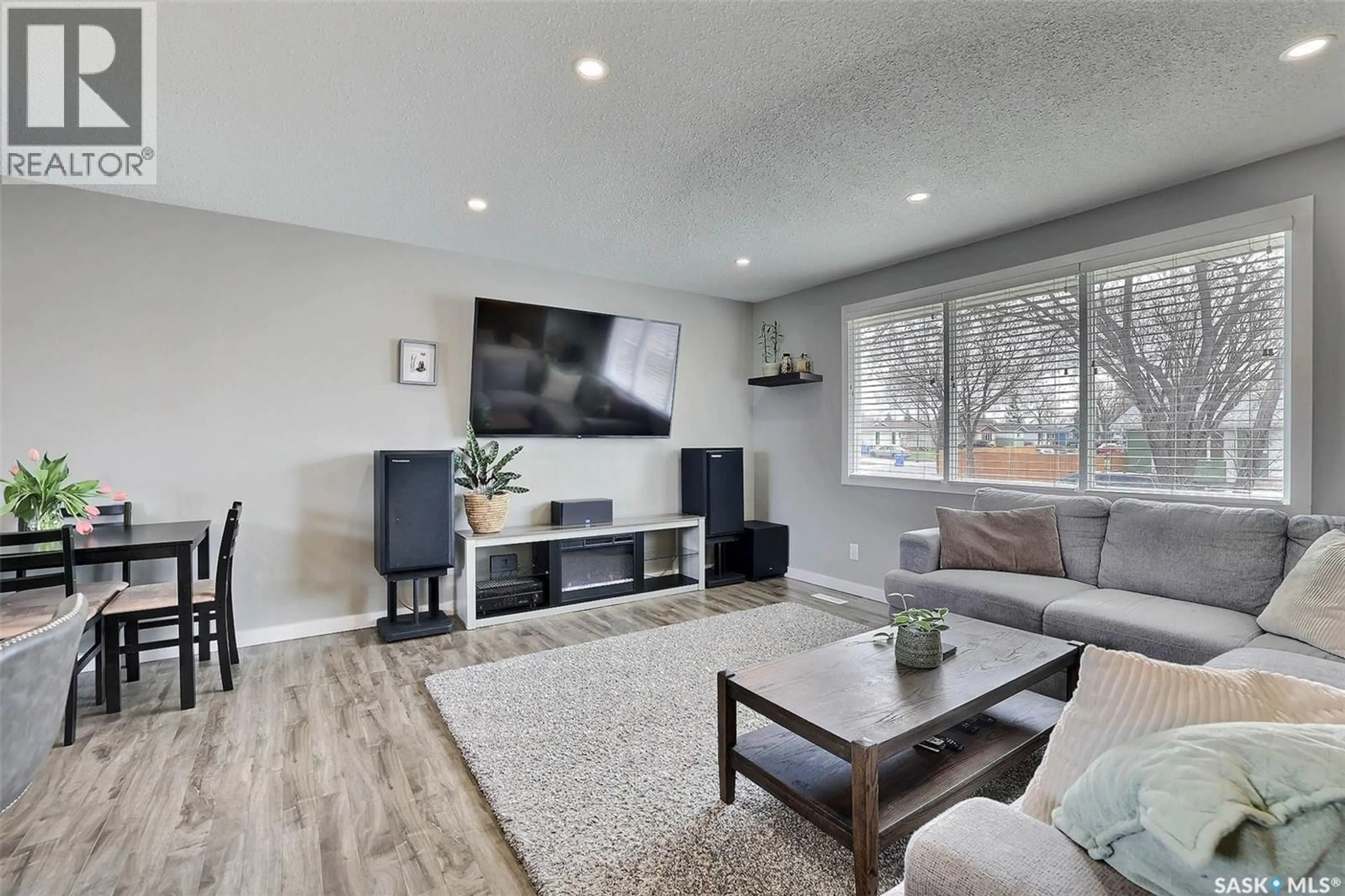 Living room with furniture, wood/laminate floor for 110 FULTON DRIVE, Regina Saskatchewan S4X1G1
