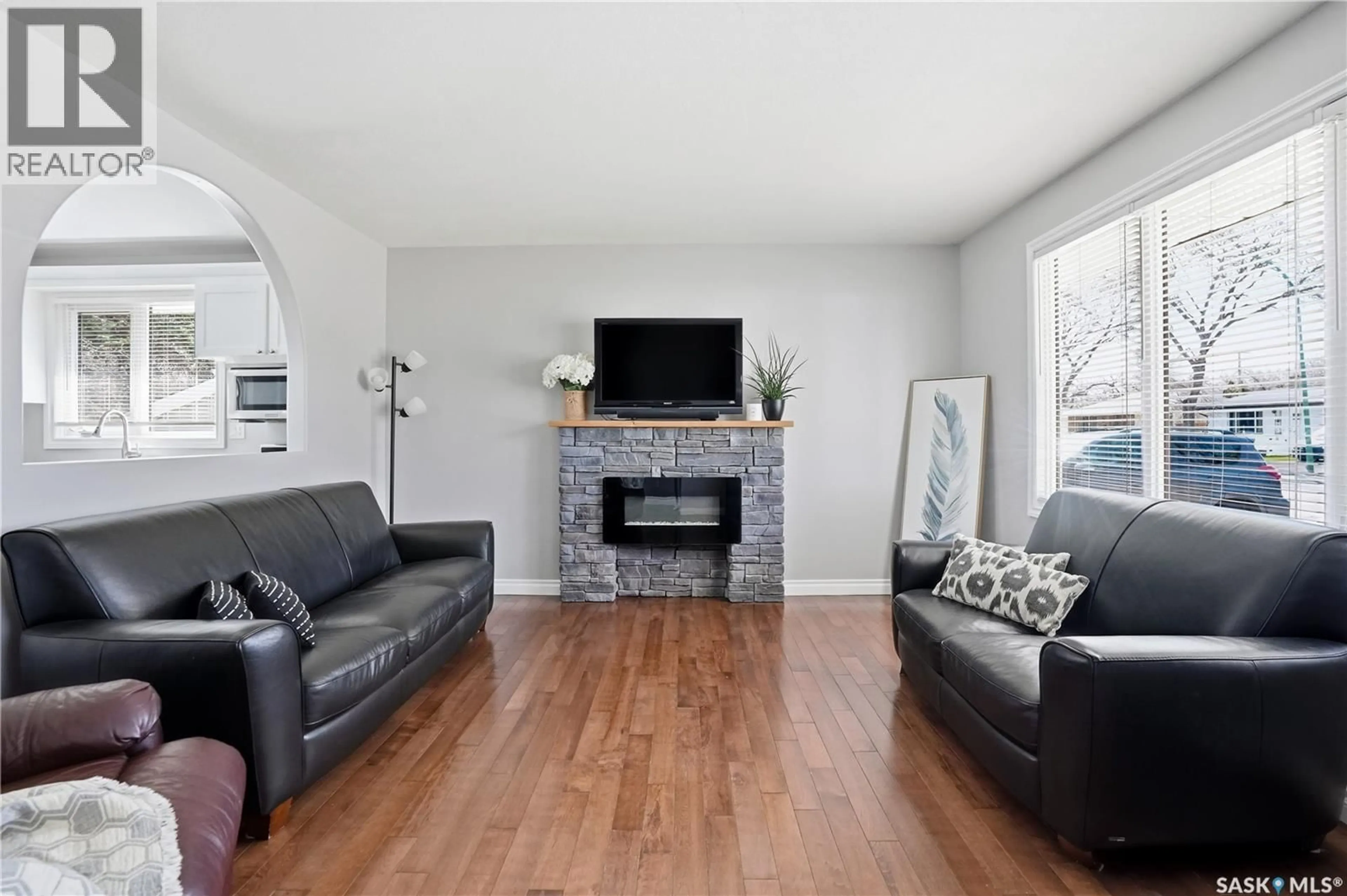 Living room with furniture, wood/laminate floor for 115 STAPLEFORD CRESCENT, Regina Saskatchewan S4R4S8