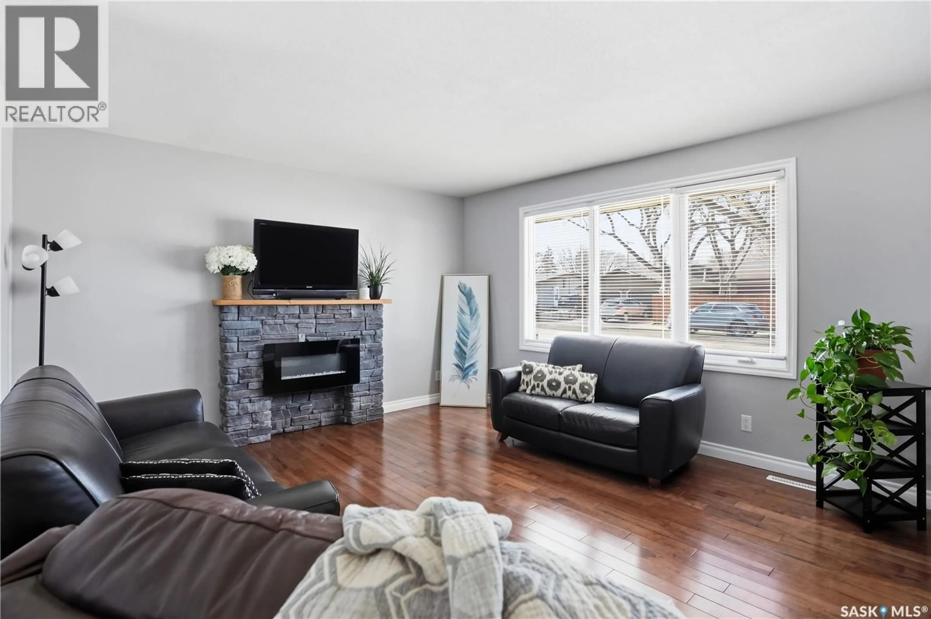Living room with furniture, wood/laminate floor for 115 STAPLEFORD CRESCENT, Regina Saskatchewan S4R4S8