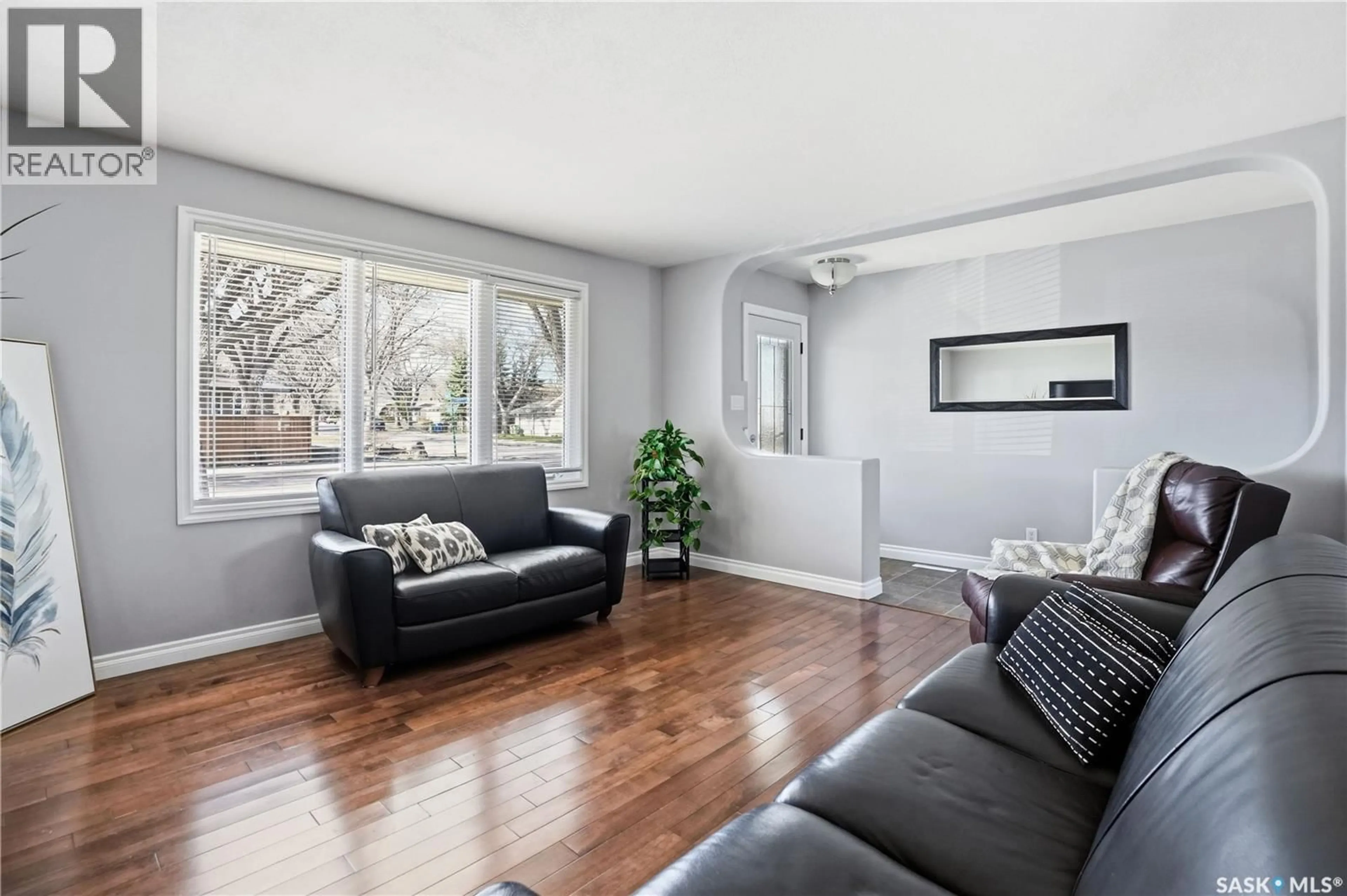 Living room with furniture, wood/laminate floor for 115 STAPLEFORD CRESCENT, Regina Saskatchewan S4R4S8