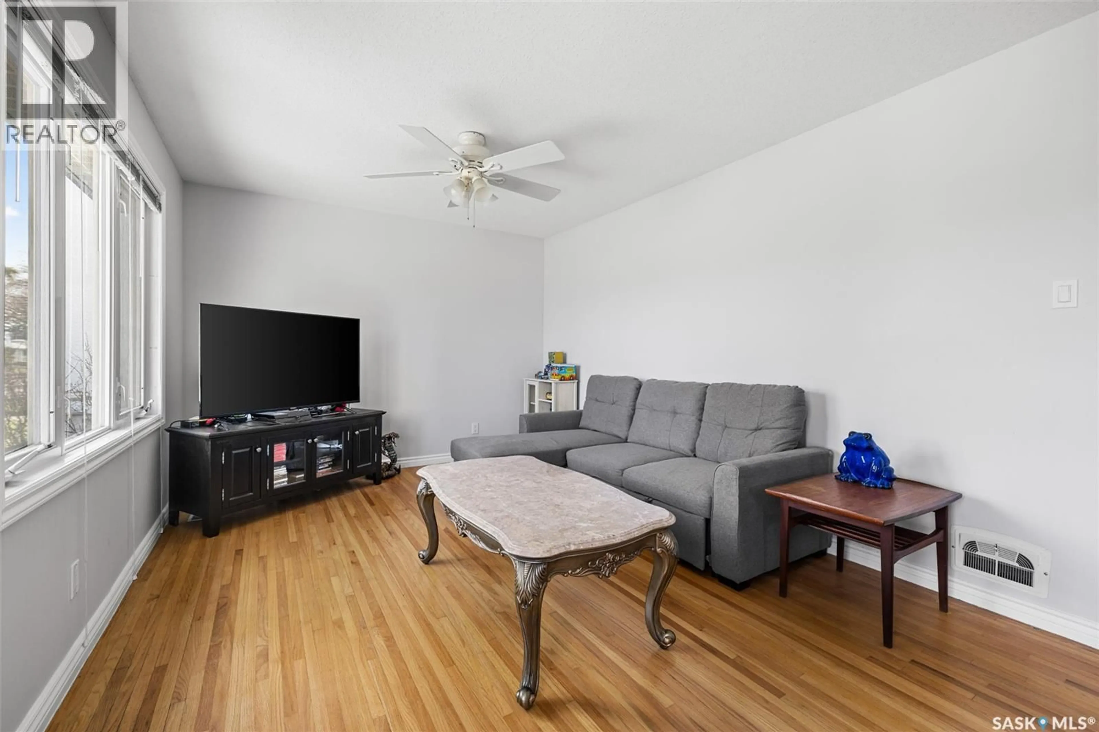 Living room with furniture, wood/laminate floor for 812 MCINTOSH STREET, Regina Saskatchewan S4T5B4