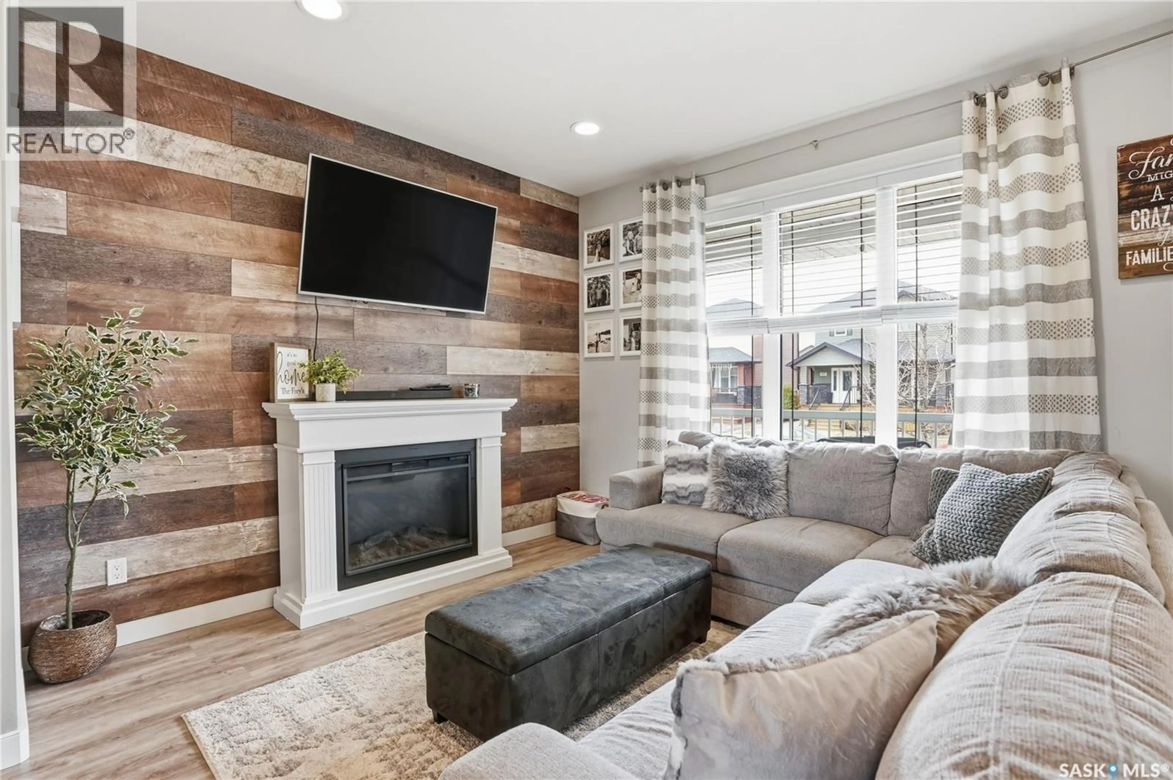 Living room with furniture, wood/laminate floor for 416 GOLDEN WILLOW WAY, Warman Saskatchewan S0K4S2