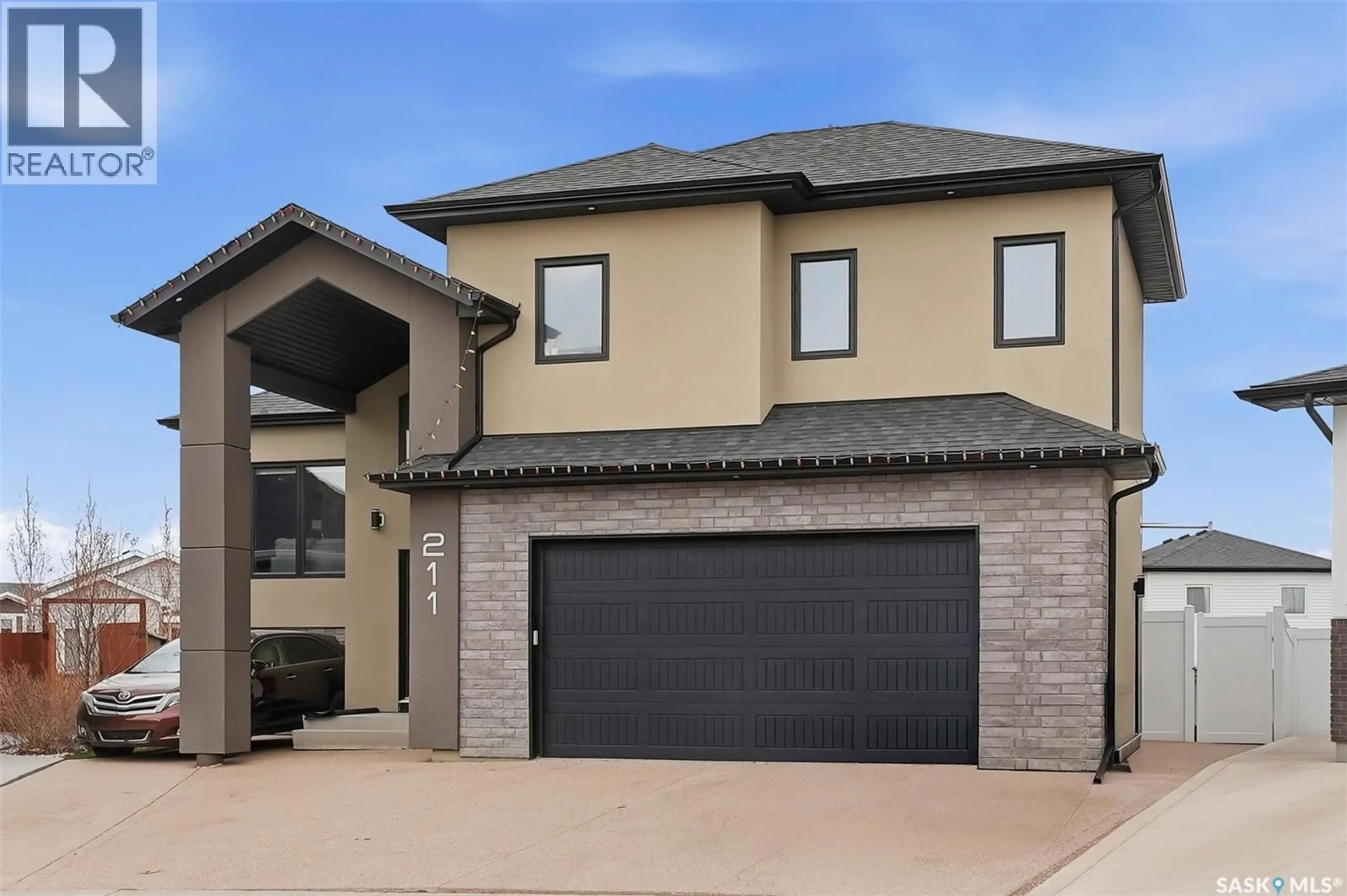 Home with brick exterior material, street for 211 BURGESS BAY, Saskatoon Saskatchewan S7V0S3