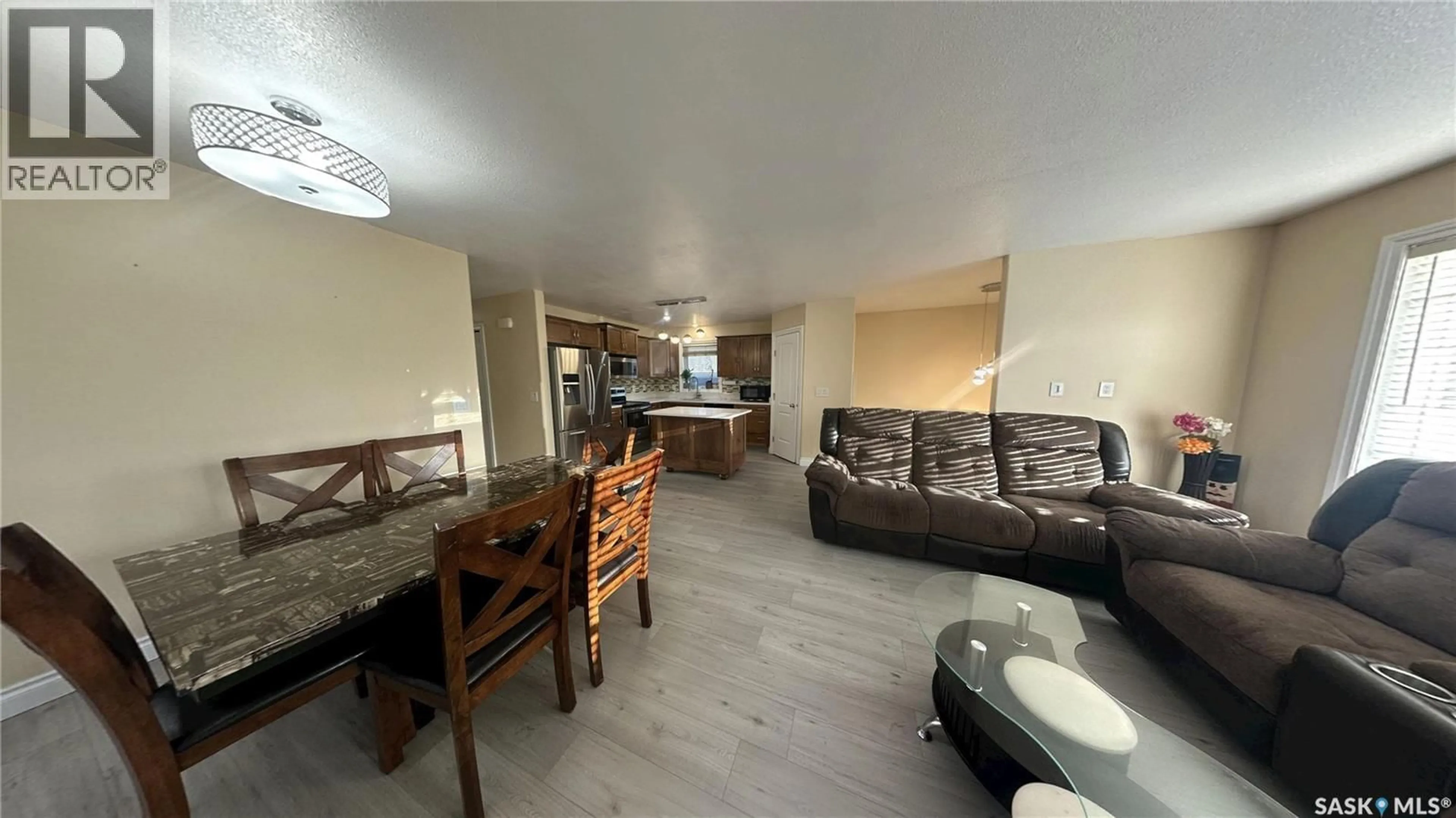 Living room with furniture, wood/laminate floor for 415 COAD MANOR, Saskatoon Saskatchewan S7R0C6