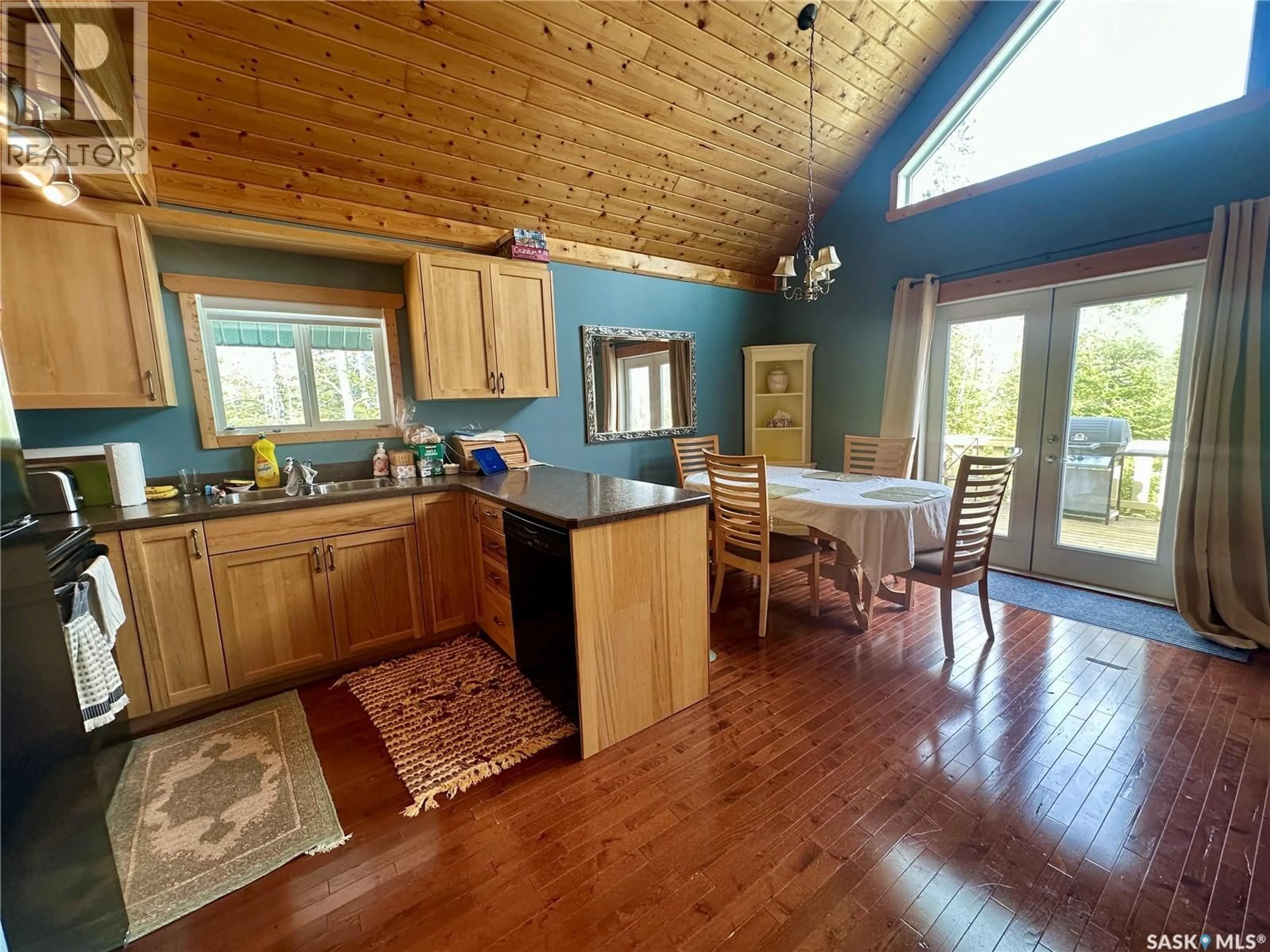 Open concept kitchen, wood/laminate floor for 2404 WAPOOS PLACE, Northern Admin District Saskatchewan S0J1L0