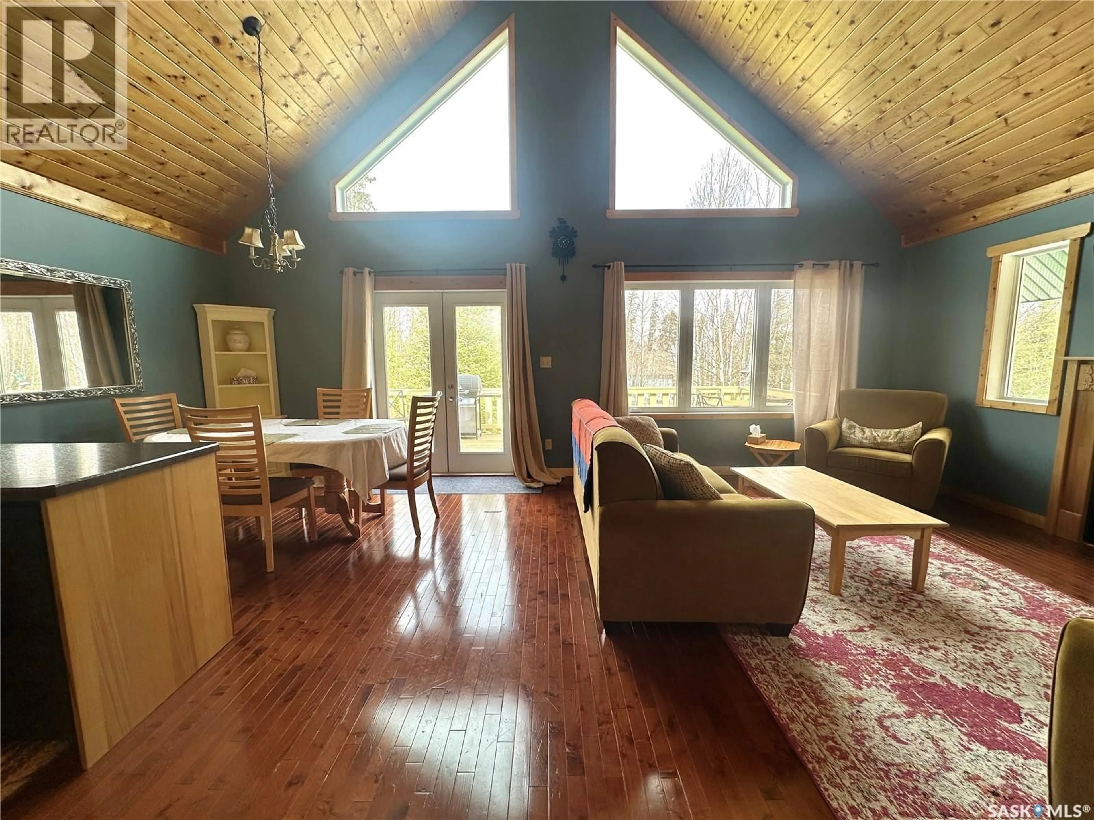 Living room with furniture, wood/laminate floor for 2404 WAPOOS PLACE, Northern Admin District Saskatchewan S0J1L0