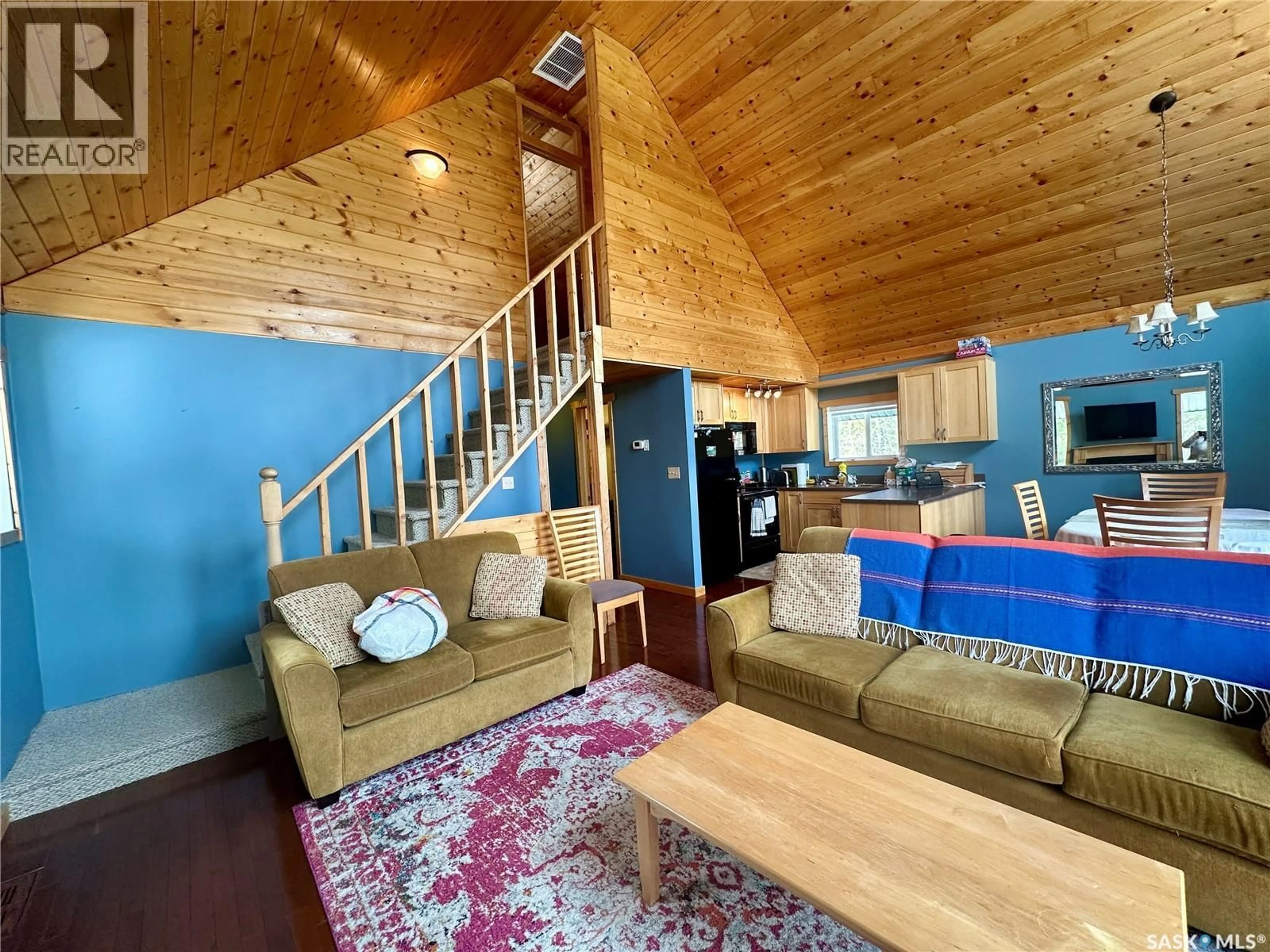 Living room with furniture, wood/laminate floor for 2404 WAPOOS PLACE, Northern Admin District Saskatchewan S0J1L0