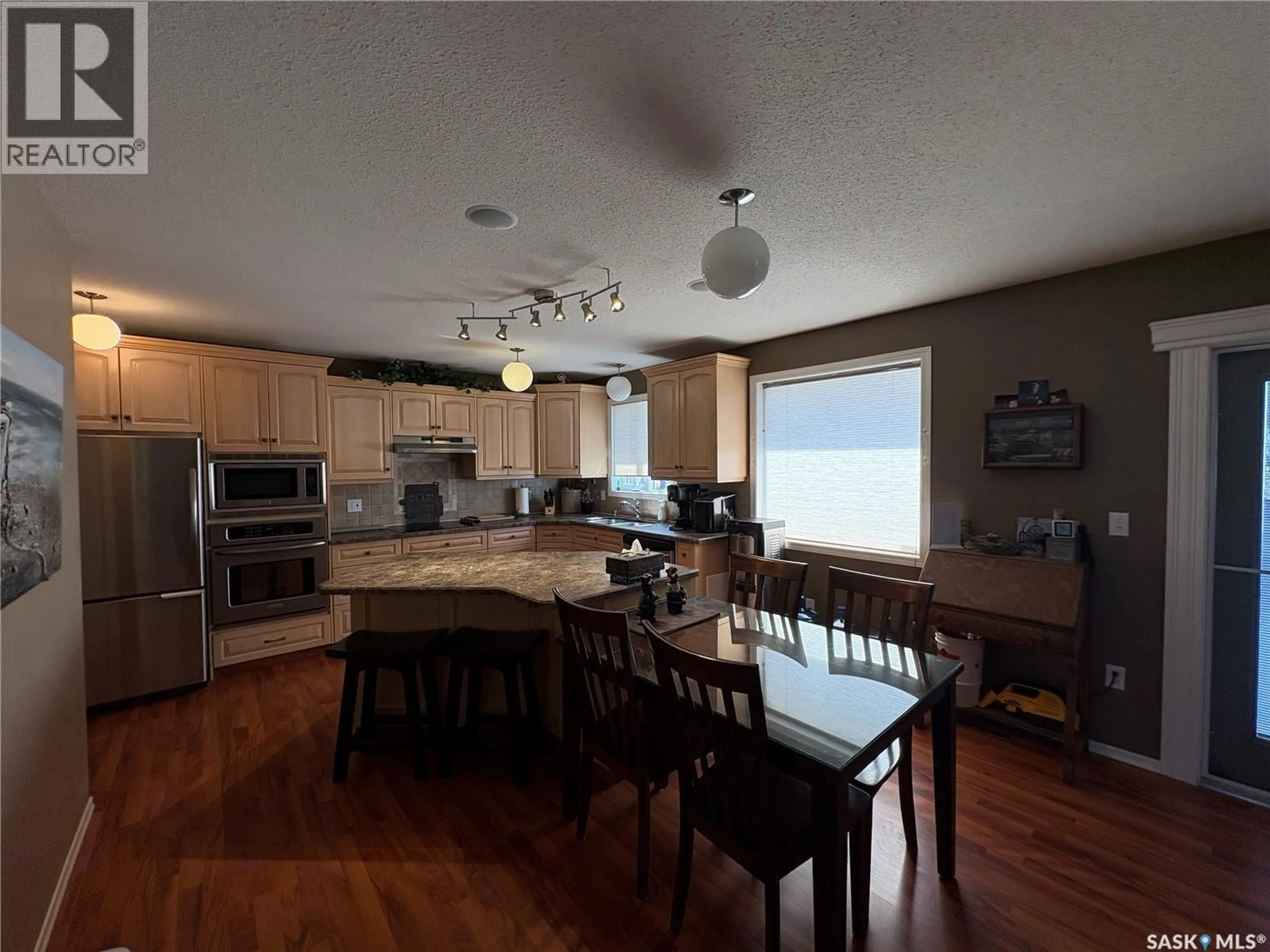 Open concept kitchen, wood/laminate floor for 115 LAKESIDE DRIVE, Fishing Lake Saskatchewan S0A1A0