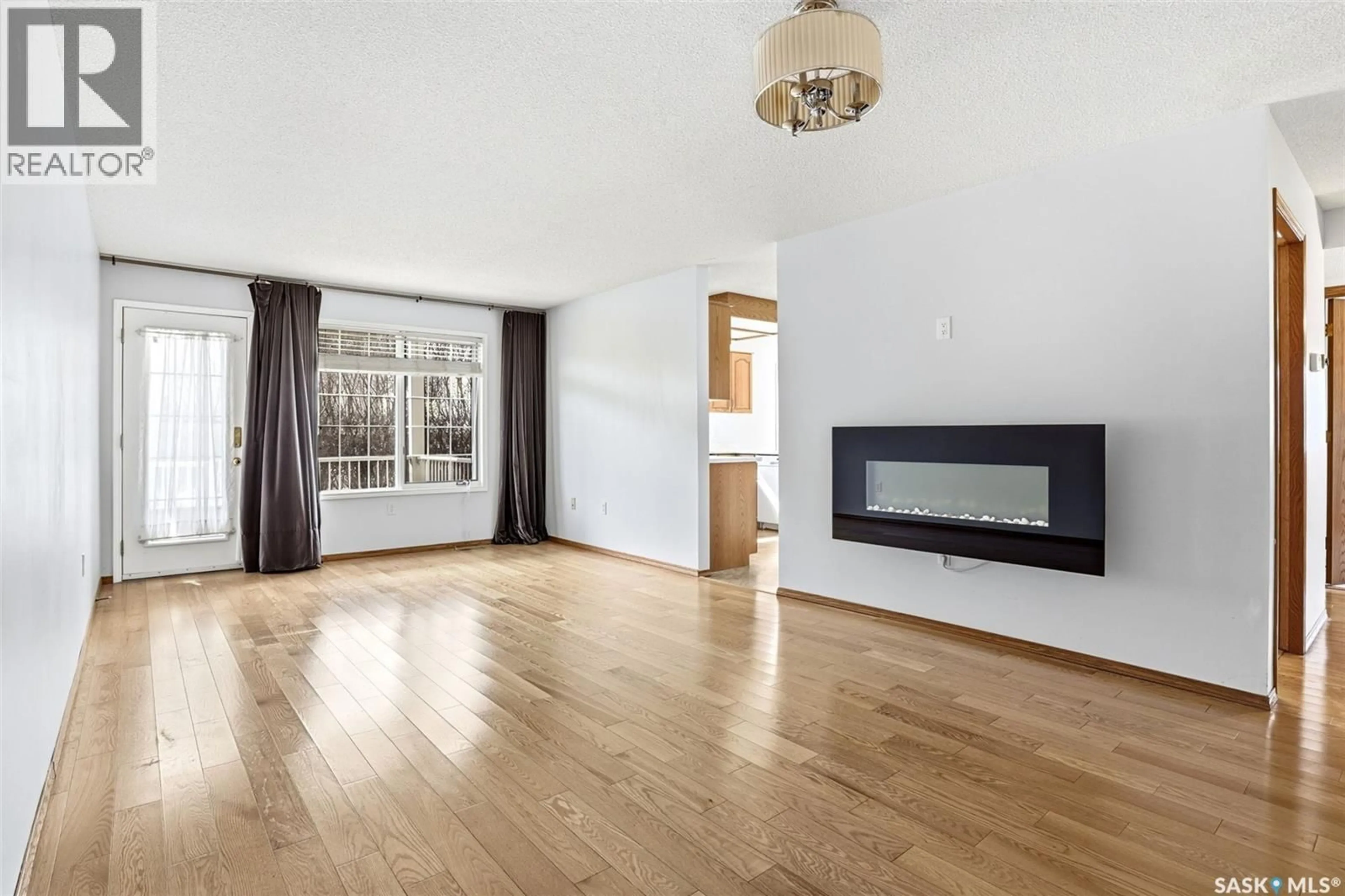 Living room with furniture, wood/laminate floor for 104 - 4025 HILL AVENUE, Regina Saskatchewan S4S0X7