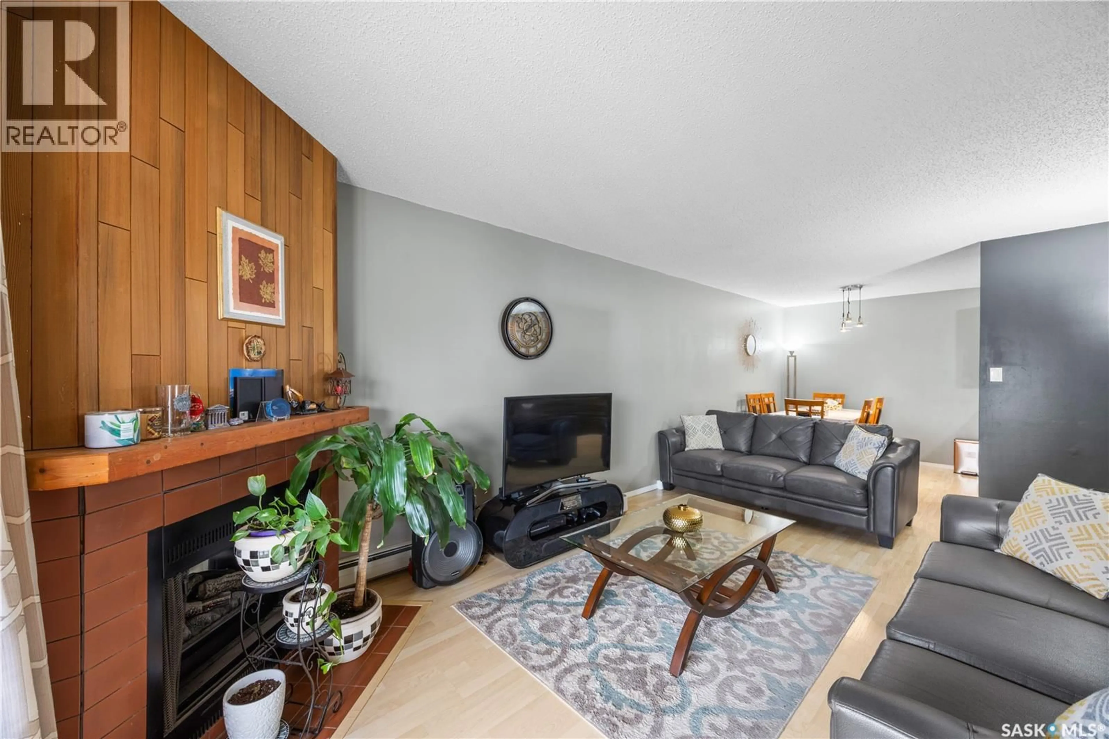 Living room with furniture, wood/laminate floor for 236 310 STILLWATER DRIVE, Saskatoon Saskatchewan S7J4H7