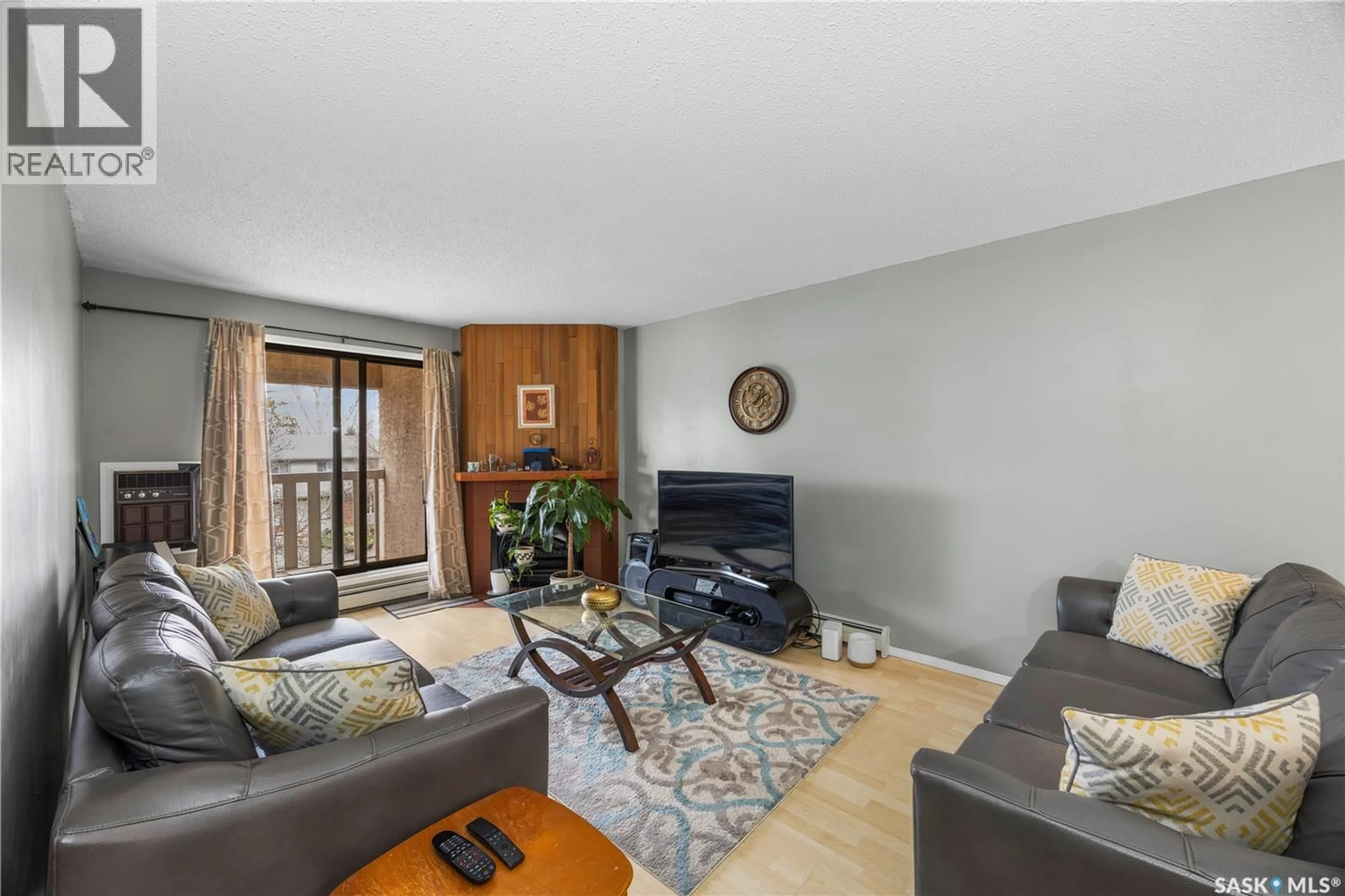 Living room with furniture, wood/laminate floor for 236 310 STILLWATER DRIVE, Saskatoon Saskatchewan S7J4H7