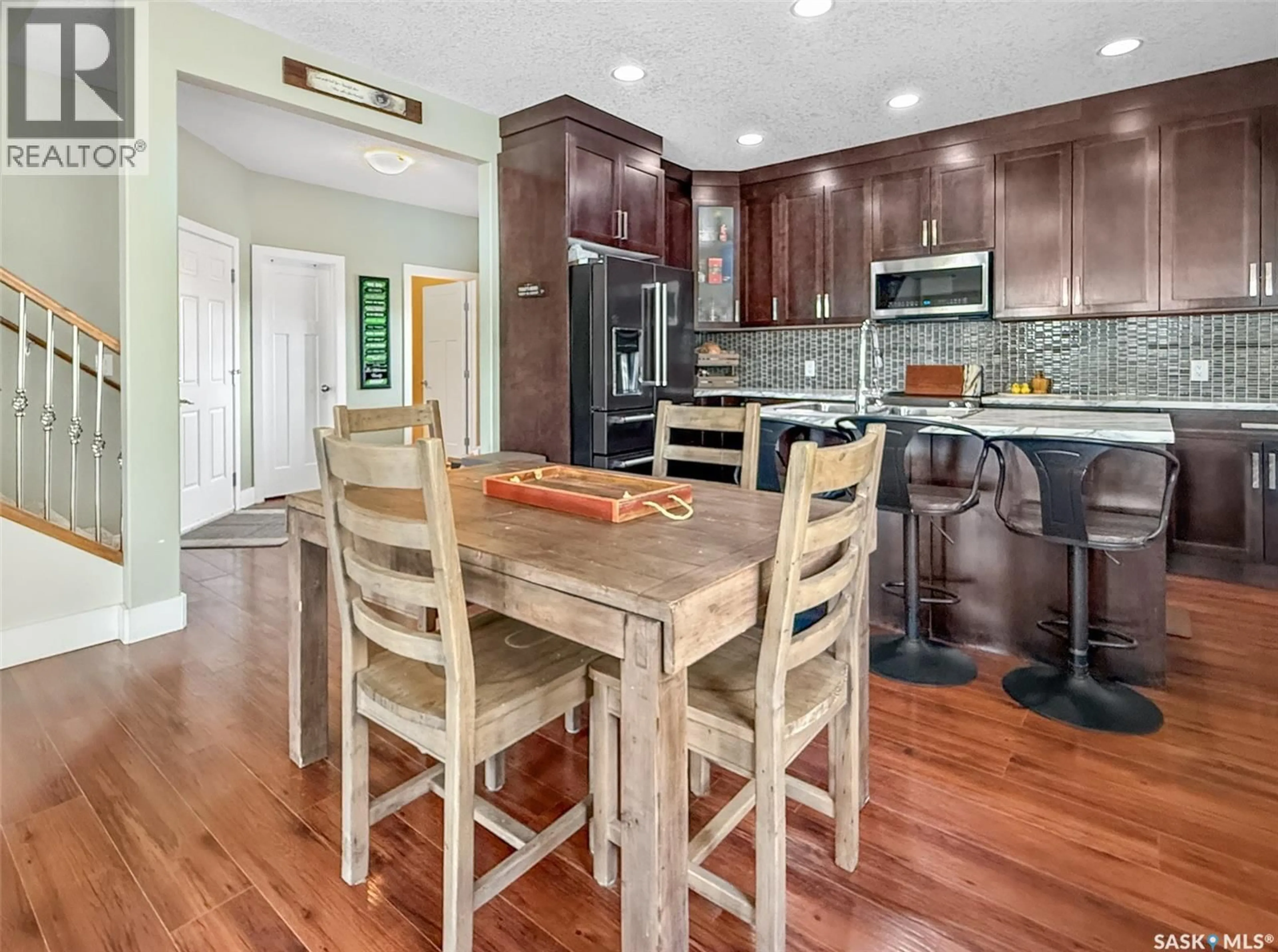 Open concept kitchen, wood/laminate floor for 137 VALLEY PARK PLACE, Swift Current Saskatchewan S9H5N2