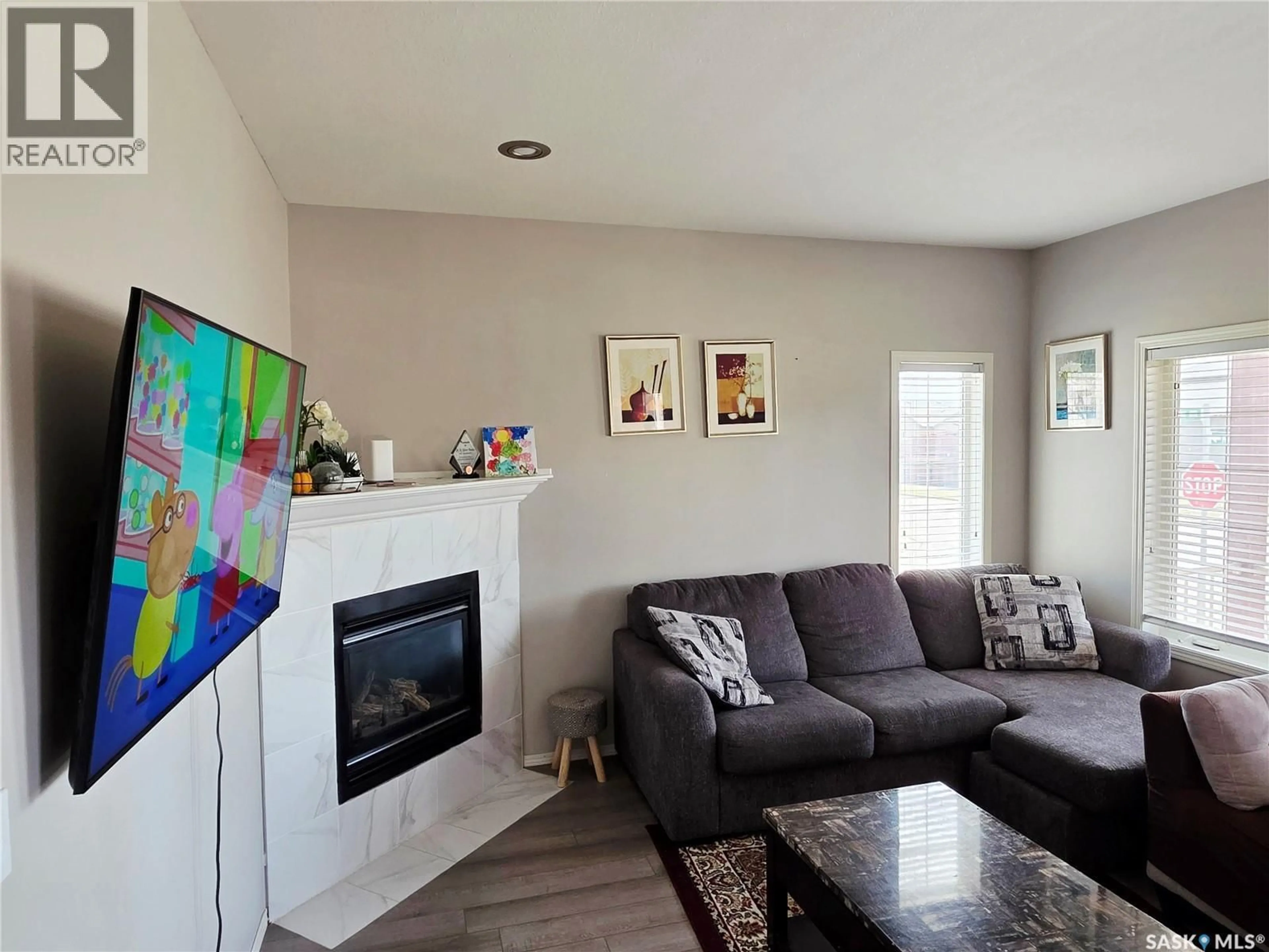 Living room with furniture, wood/laminate floor for 531 GORDON ROAD, Saskatoon Saskatchewan S7T0A7
