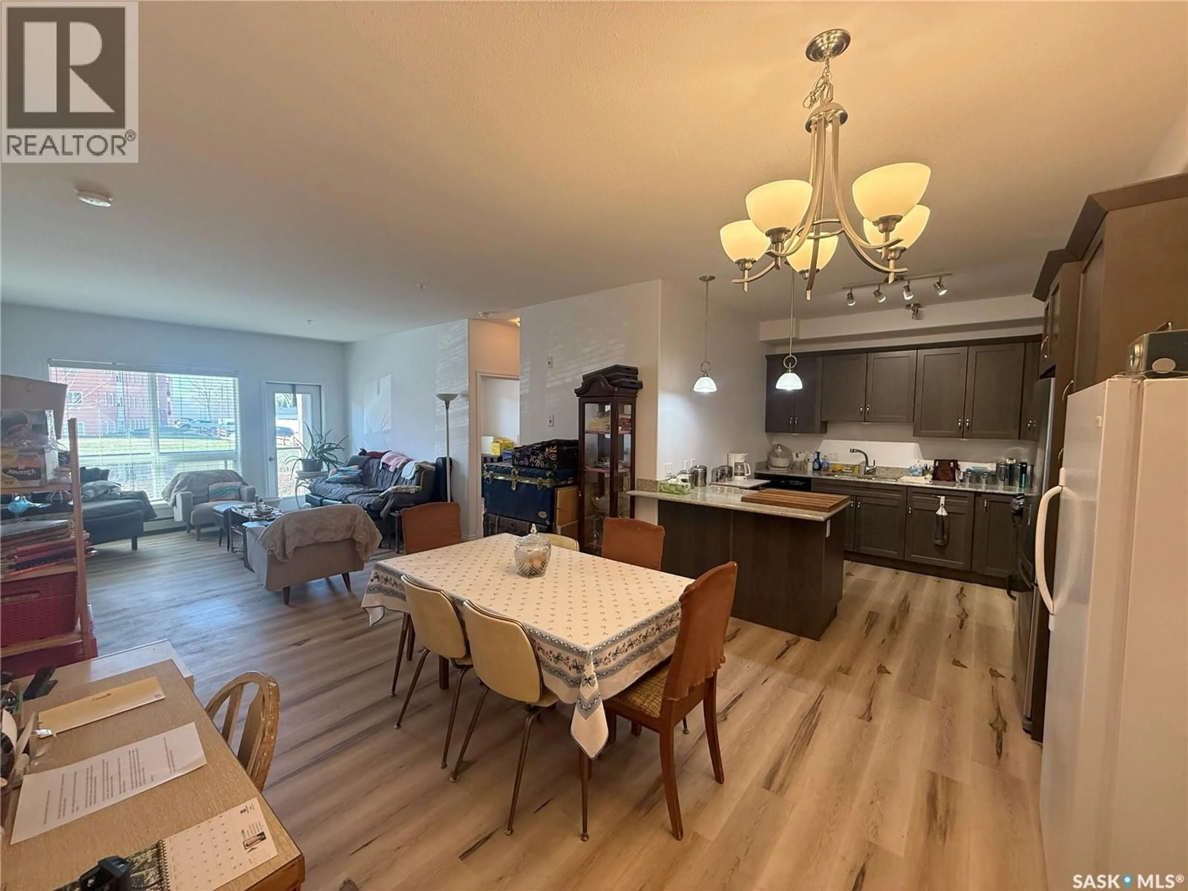 Open concept kitchen, wood/laminate floor for 128 2710 MAIN STREET, Saskatoon Saskatchewan S7H0M3