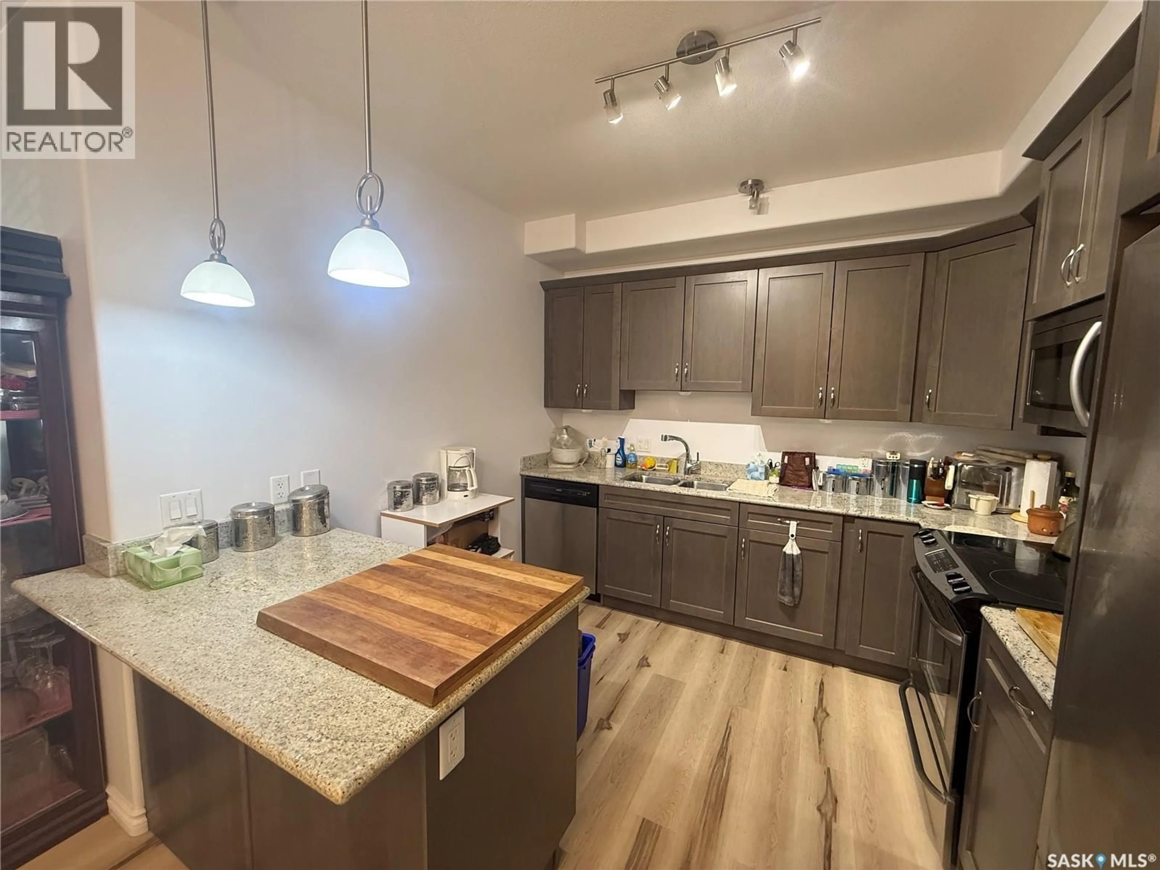 Open concept kitchen, wood/laminate floor for 128 2710 MAIN STREET, Saskatoon Saskatchewan S7H0M3