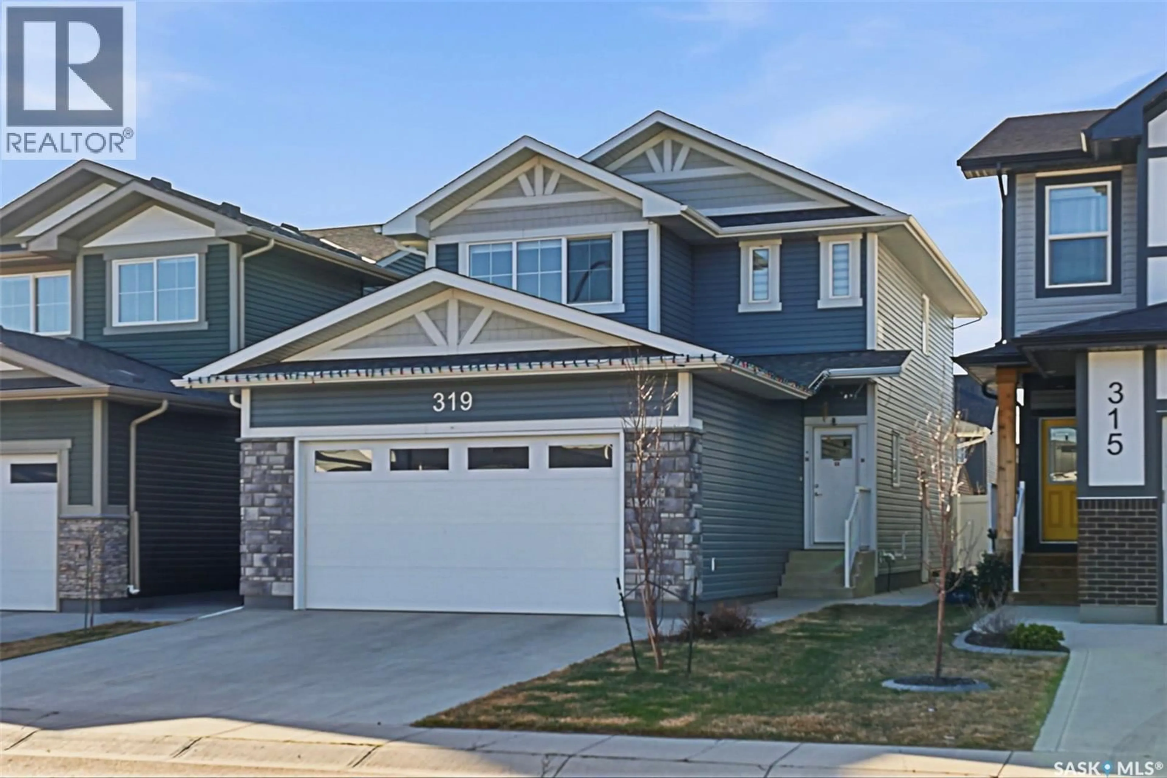 Home with vinyl exterior material, street for 319 SKOPIK CRESCENT, Saskatoon Saskatchewan S7V0V5