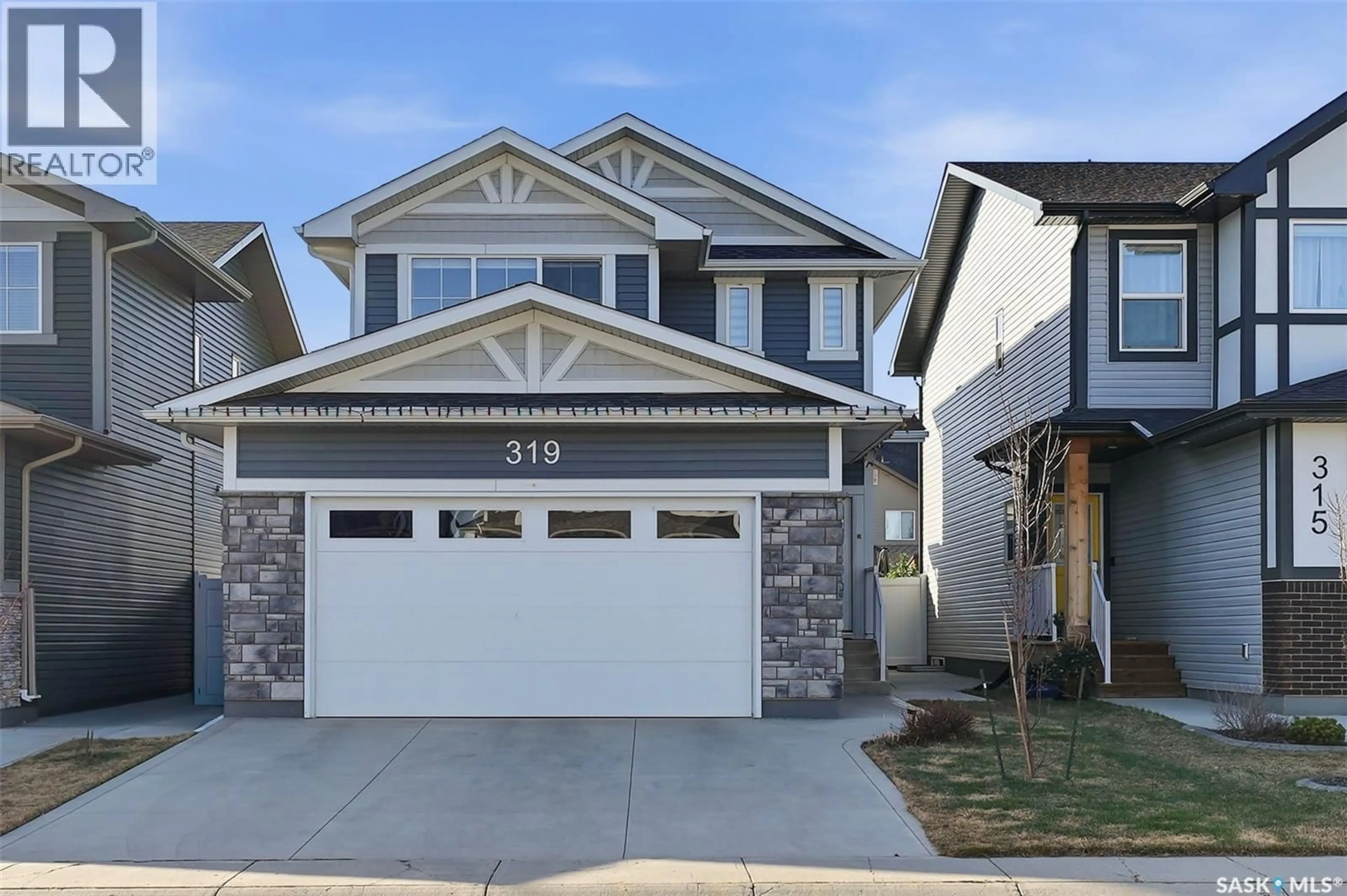 Home with vinyl exterior material, street for 319 SKOPIK CRESCENT, Saskatoon Saskatchewan S7V0V5