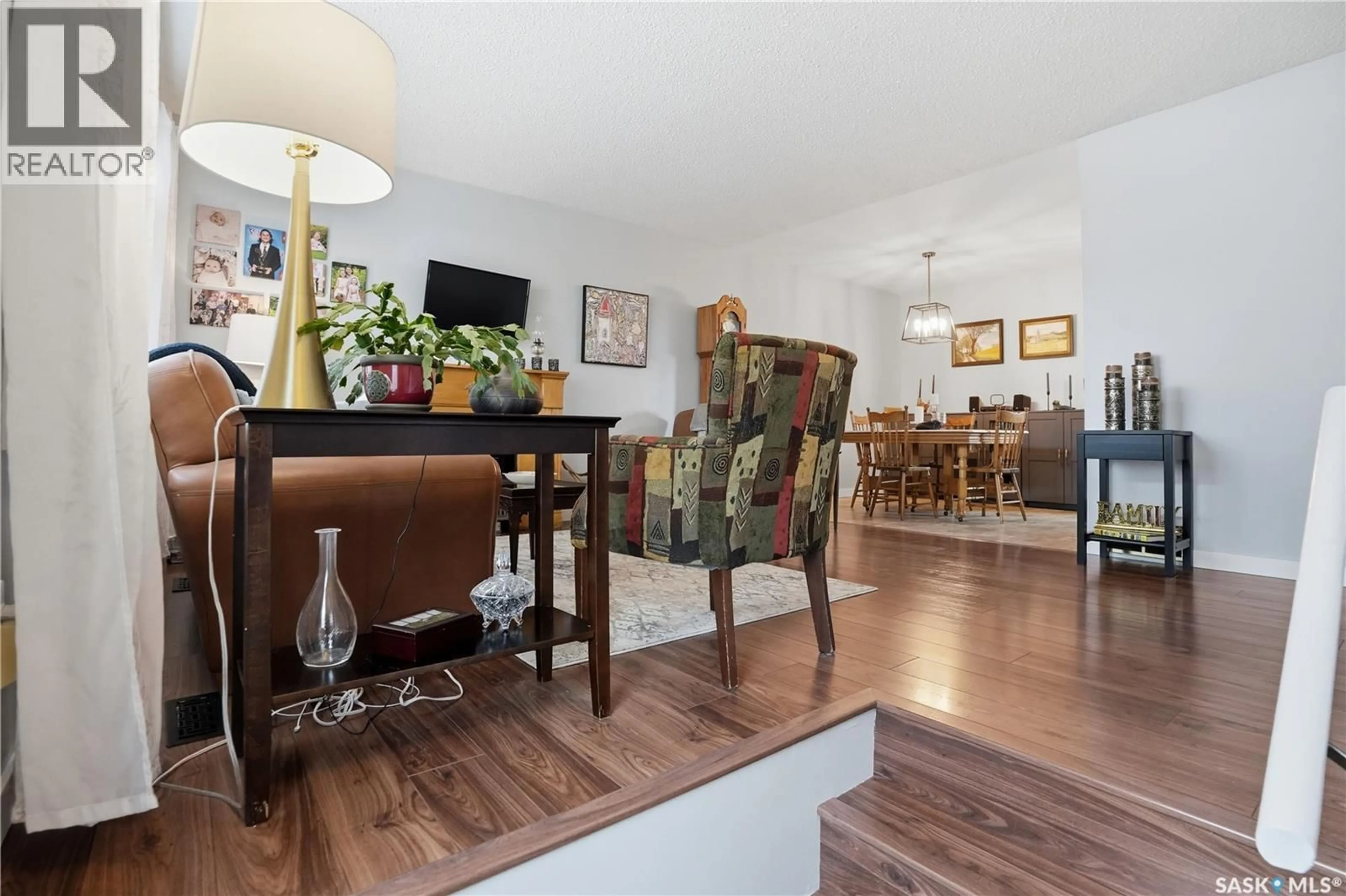 Living room with furniture, wood/laminate floor for 95 SCHNEIDER CRESCENT, Regina Saskatchewan S4R7R6