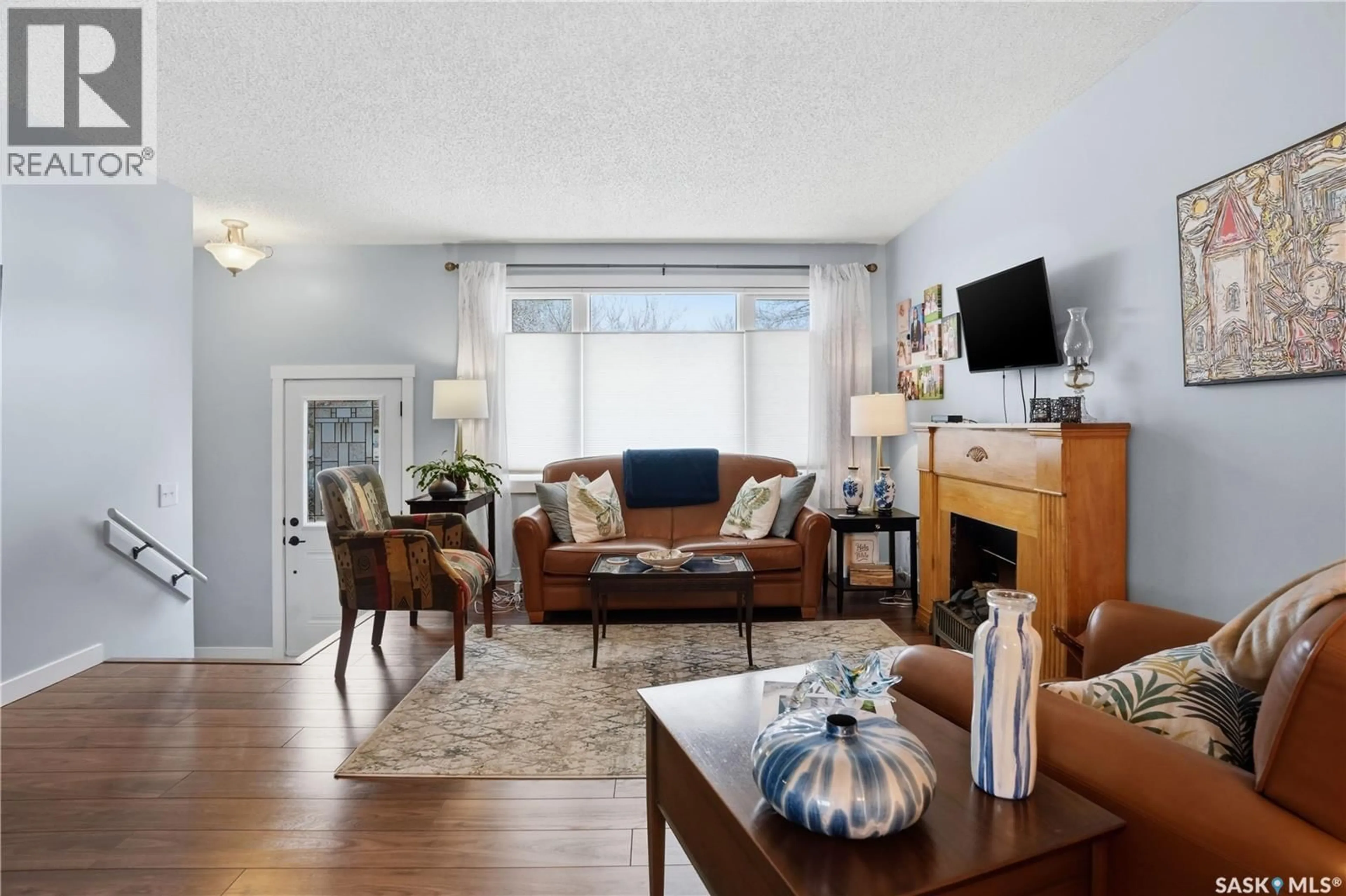 Living room with furniture, wood/laminate floor for 95 SCHNEIDER CRESCENT, Regina Saskatchewan S4R7R6