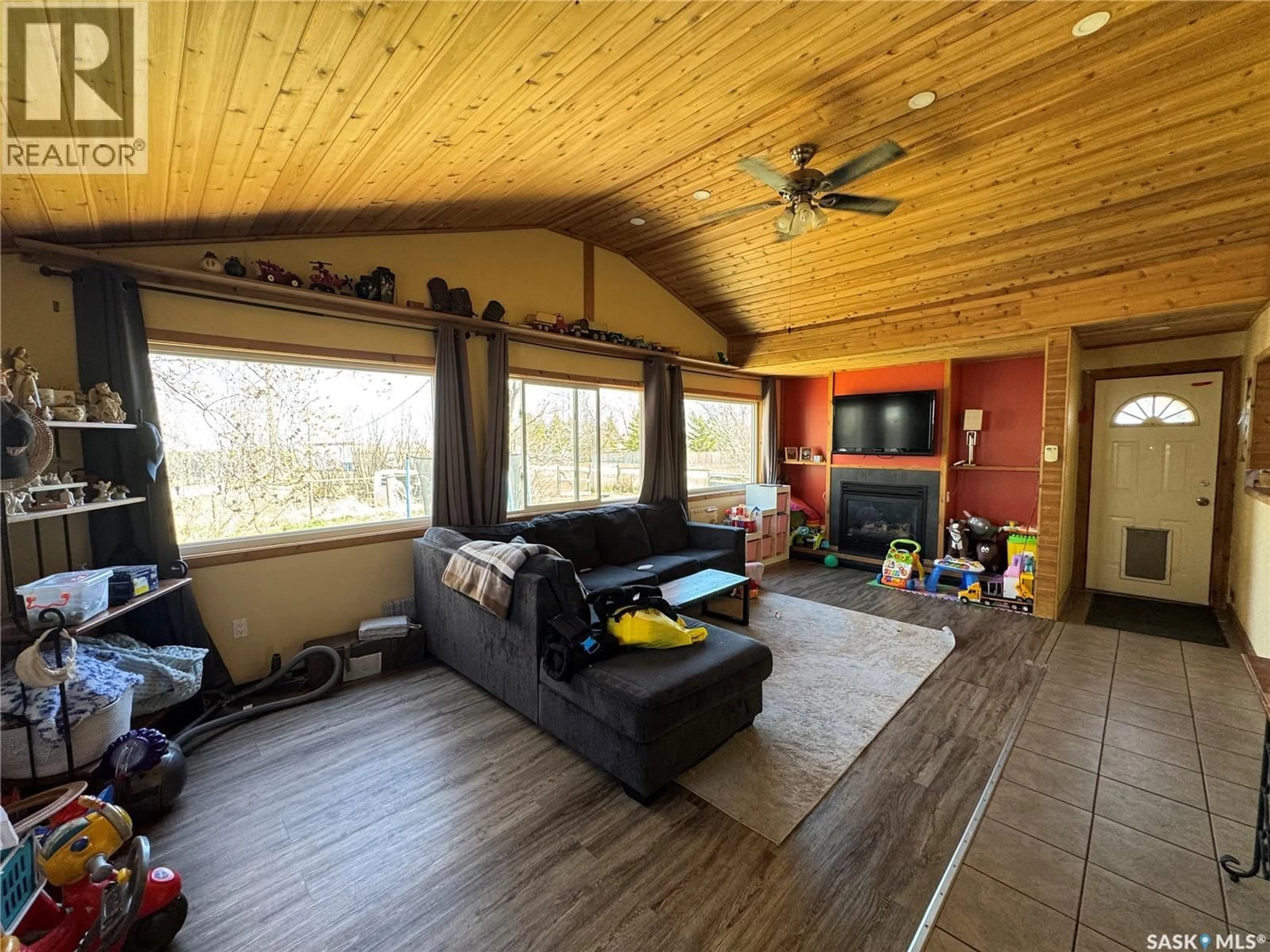 Living room with furniture, wood/laminate floor for 381 2ND STREET, Disley Saskatchewan S0G0H0