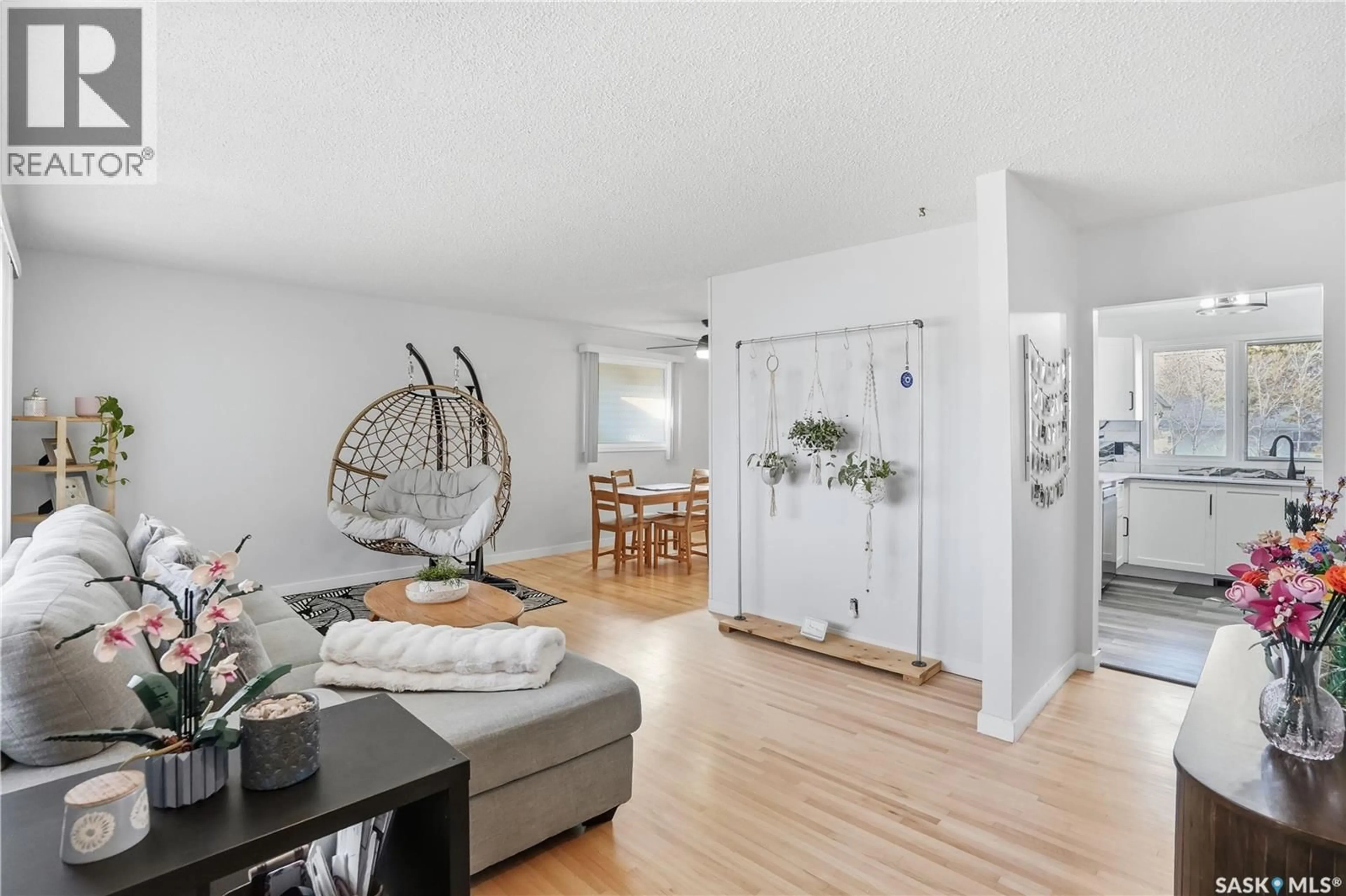 Living room with furniture, wood/laminate floor for 245 ORCHARD CRESCENT, Regina Saskatchewan S4S5B9
