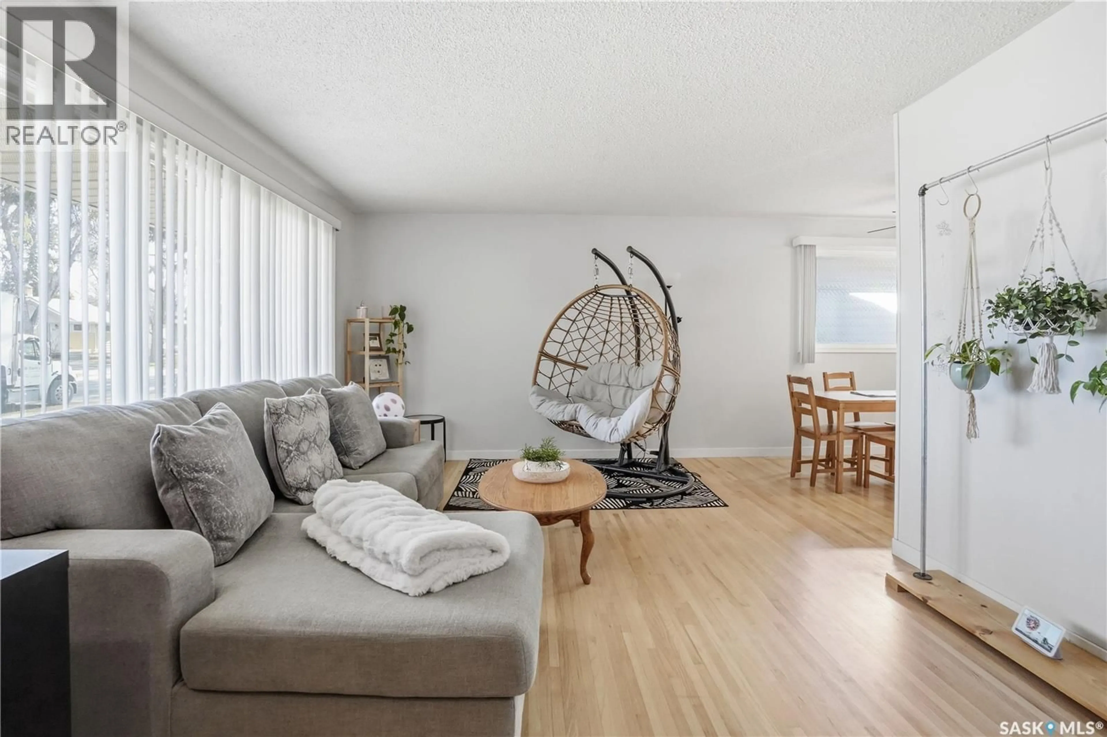 Living room with furniture, wood/laminate floor for 245 ORCHARD CRESCENT, Regina Saskatchewan S4S5B9
