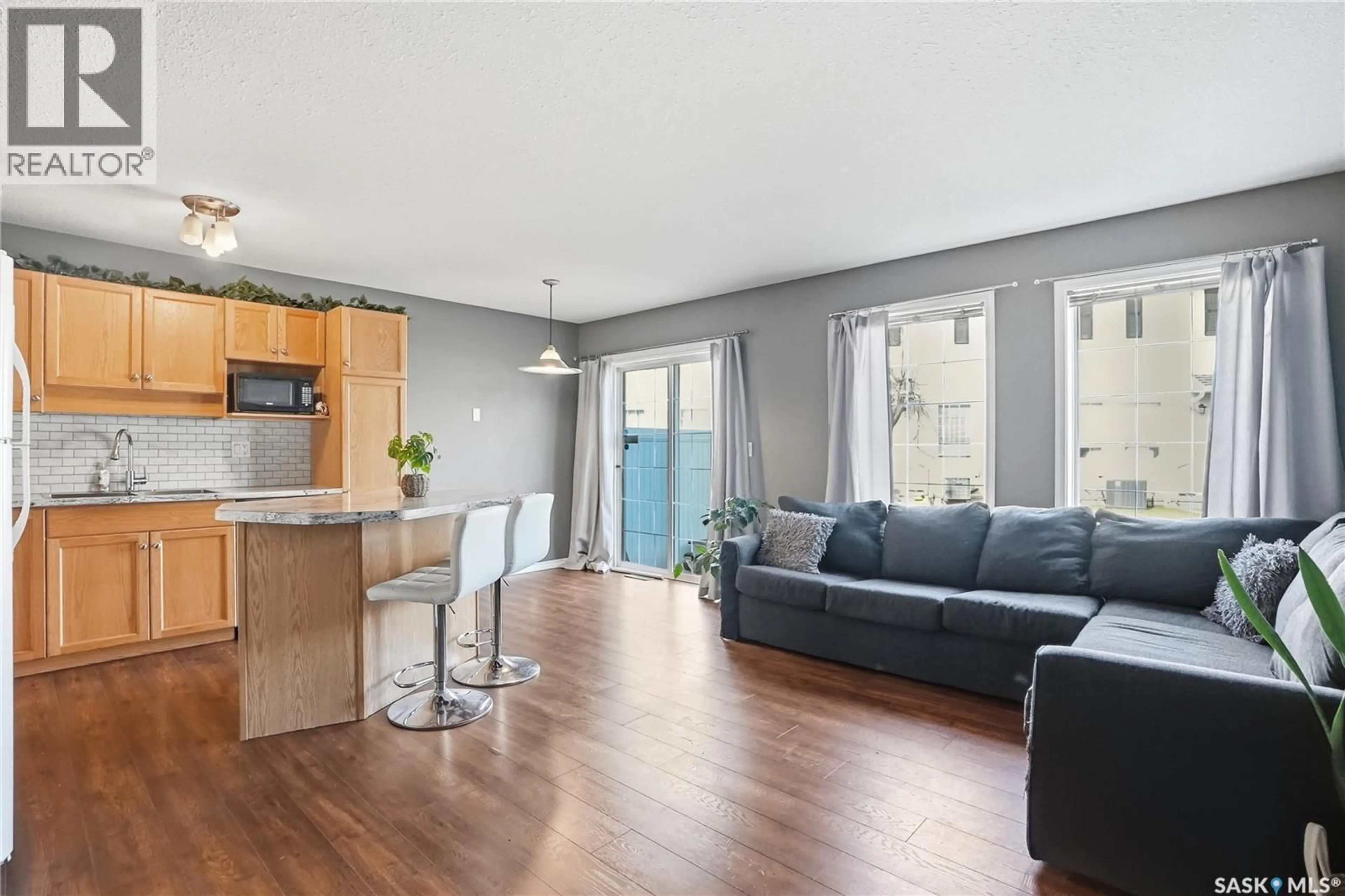 Living room with furniture, wood/laminate floor for 81 103 BANYAN CRESCENT, Saskatoon Saskatchewan S7V1G4