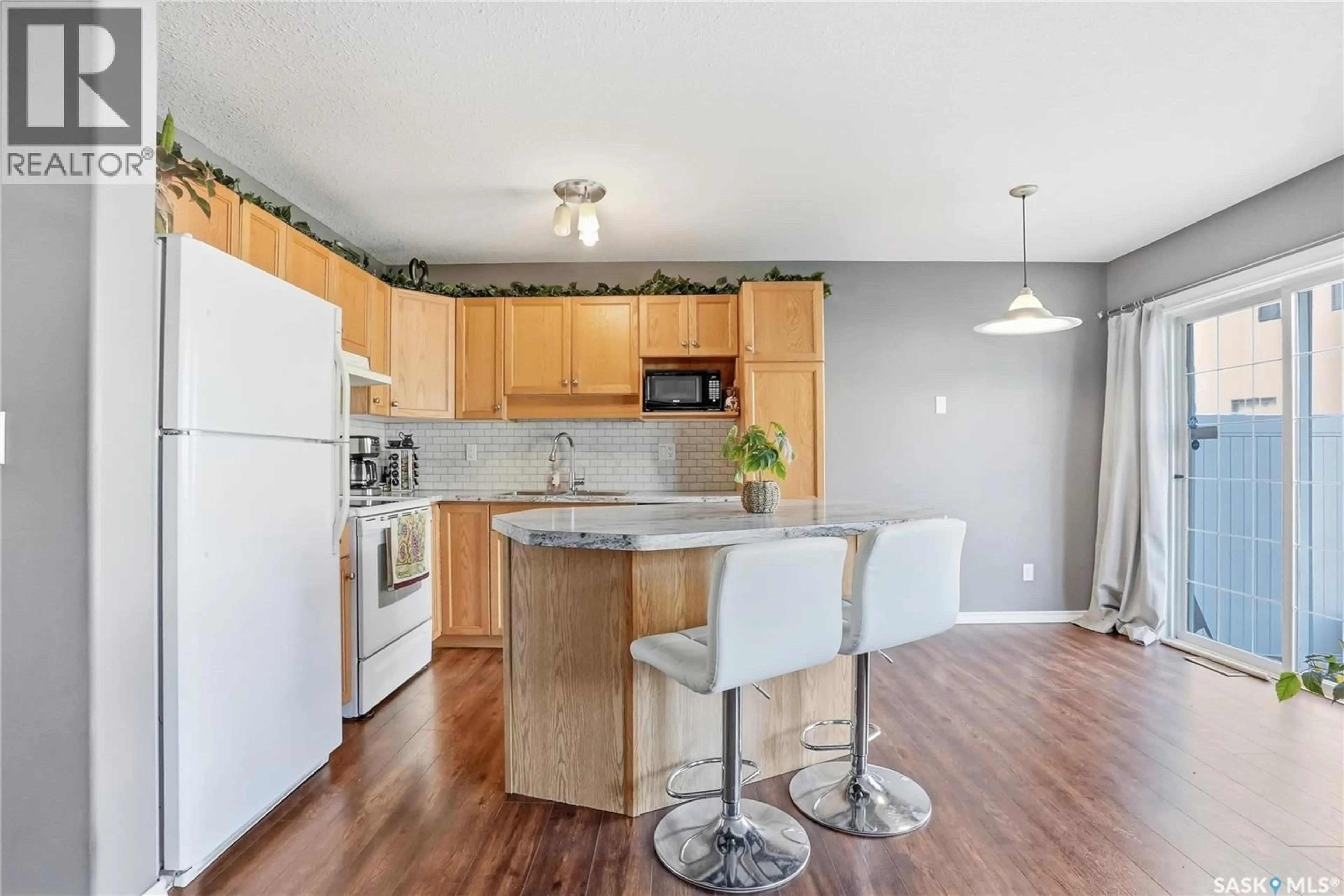 Open concept kitchen, wood/laminate floor for 81 103 BANYAN CRESCENT, Saskatoon Saskatchewan S7V1G4