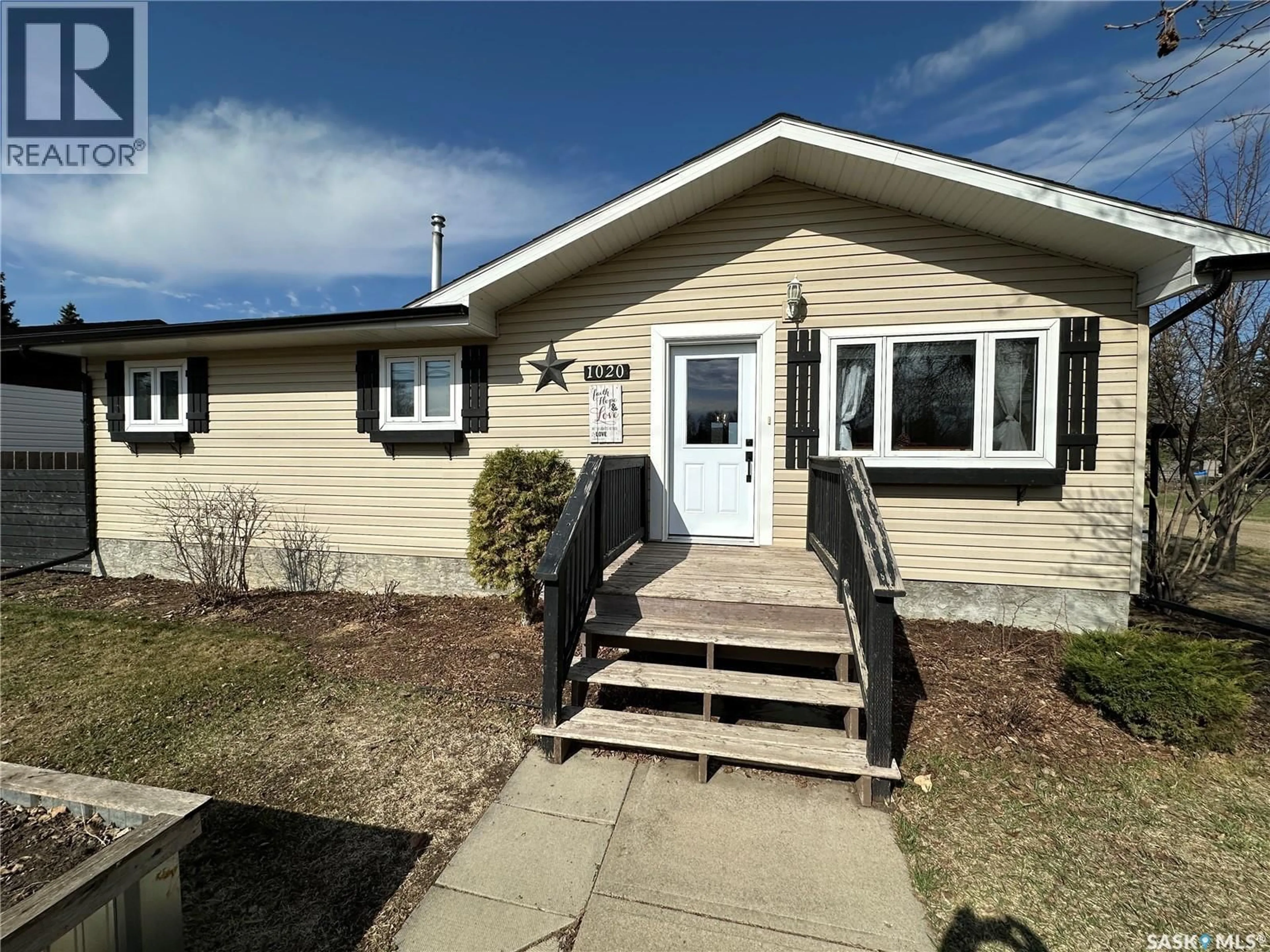 Home with vinyl exterior material, street for 1020 4TH AVENUE, Rosthern Saskatchewan S0K3R0