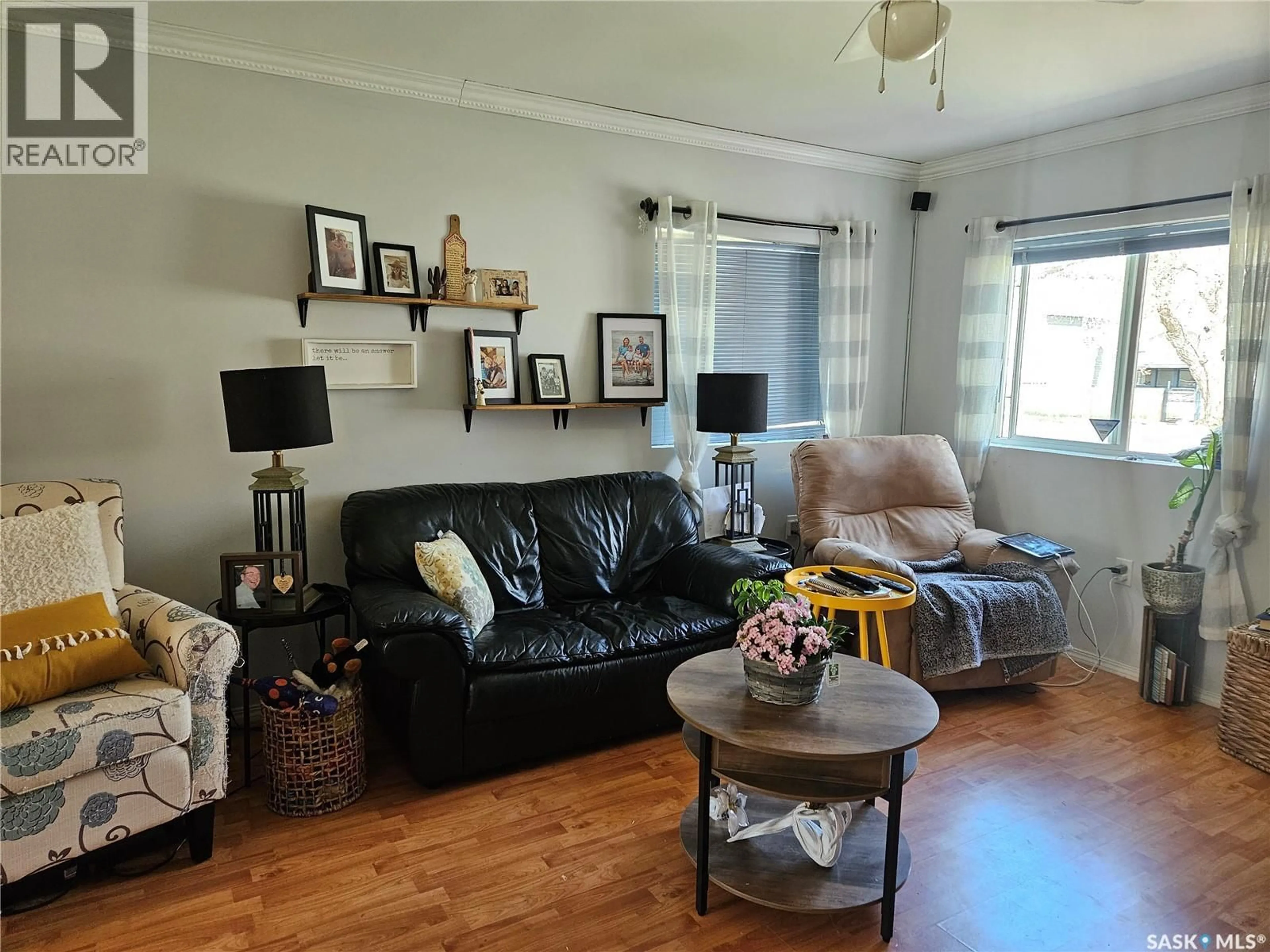 Living room with furniture, wood/laminate floor for 219 LILLOOET STREET, Moose Jaw Saskatchewan S6H4Z1