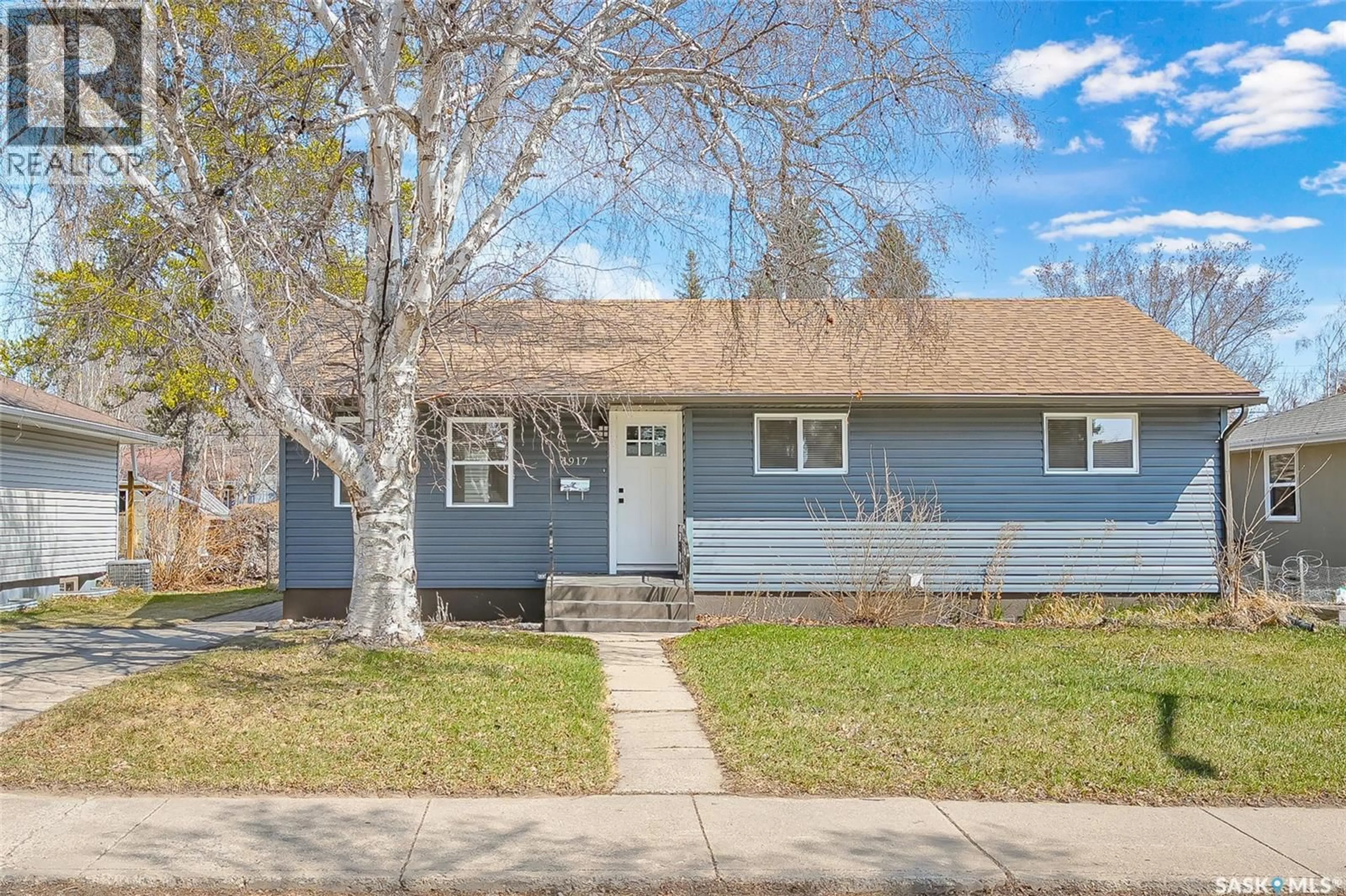 Home with vinyl exterior material, street for 1917 CAIRNS AVENUE, Saskatoon Saskatchewan S7J1T3