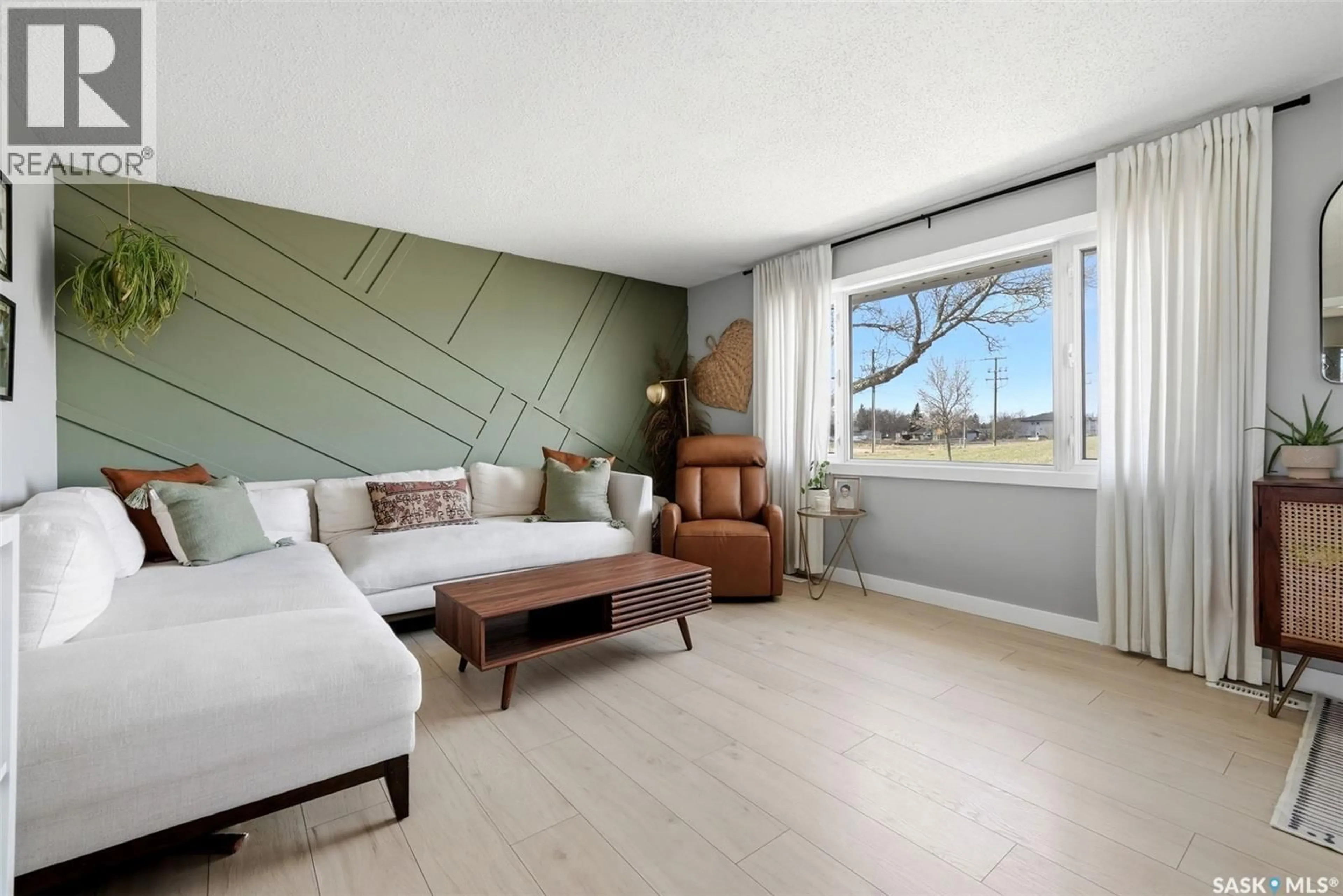 Living room with furniture, wood/laminate floor for 5721 MCKINLEY AVENUE, Regina Saskatchewan S4T7L3