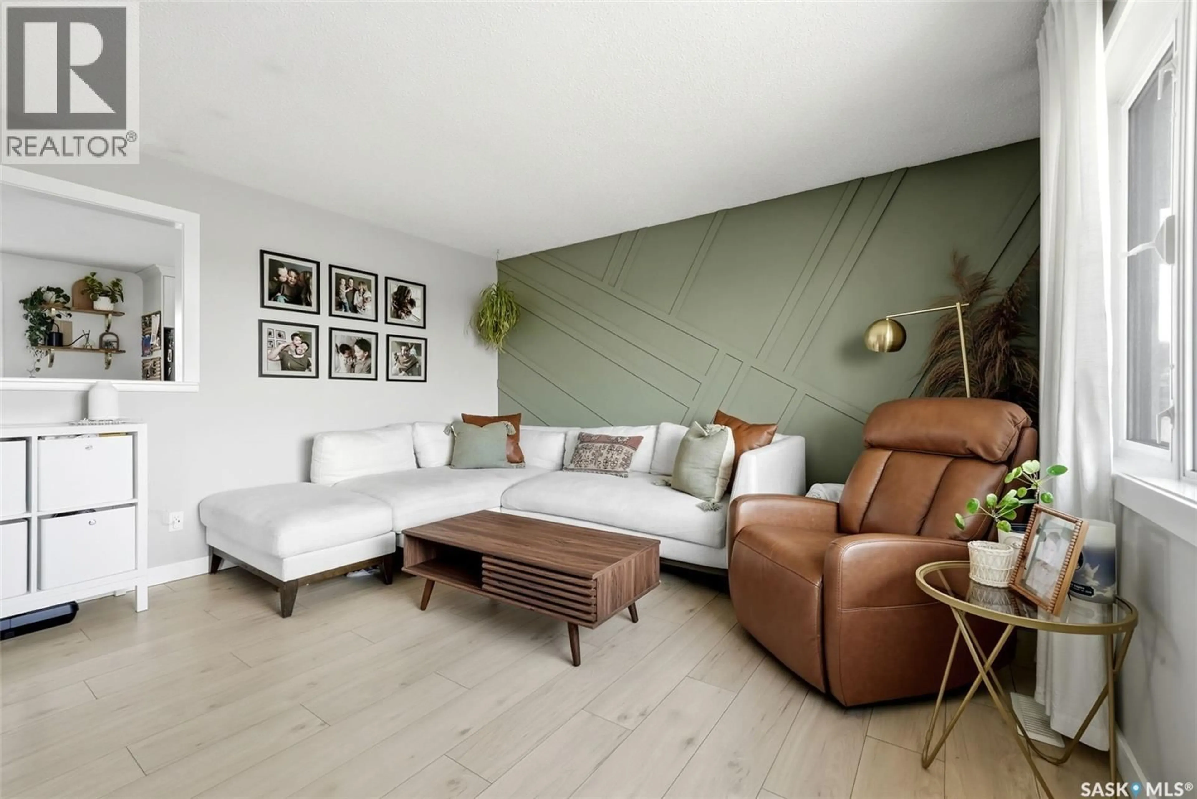 Living room with furniture, wood/laminate floor for 5721 MCKINLEY AVENUE, Regina Saskatchewan S4T7L3
