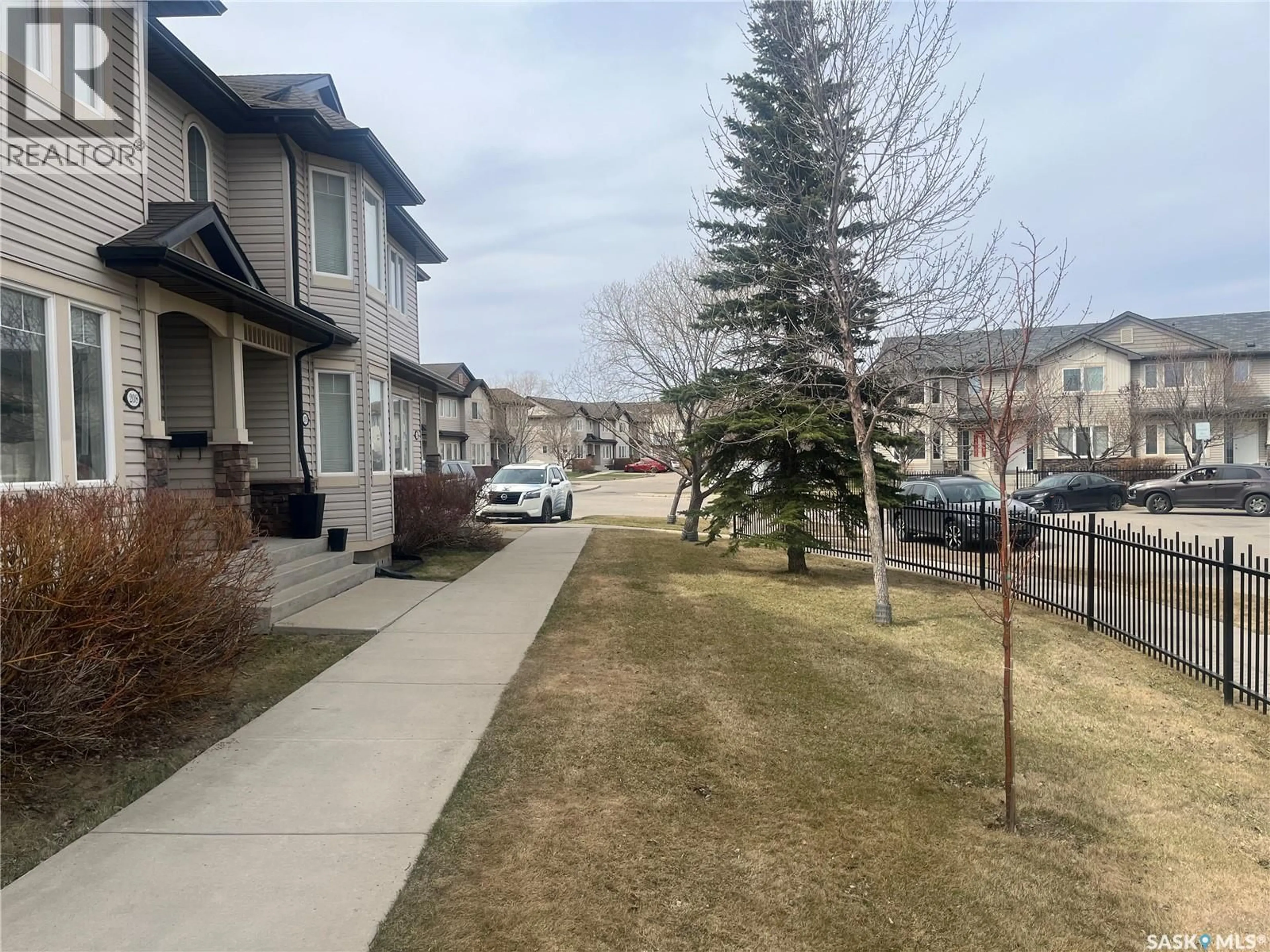A pic from outside/outdoor area/front of a property/back of a property/a pic from drone, street for 207 - 303 SLIMMON PLACE, Saskatoon Saskatchewan S7V0A8