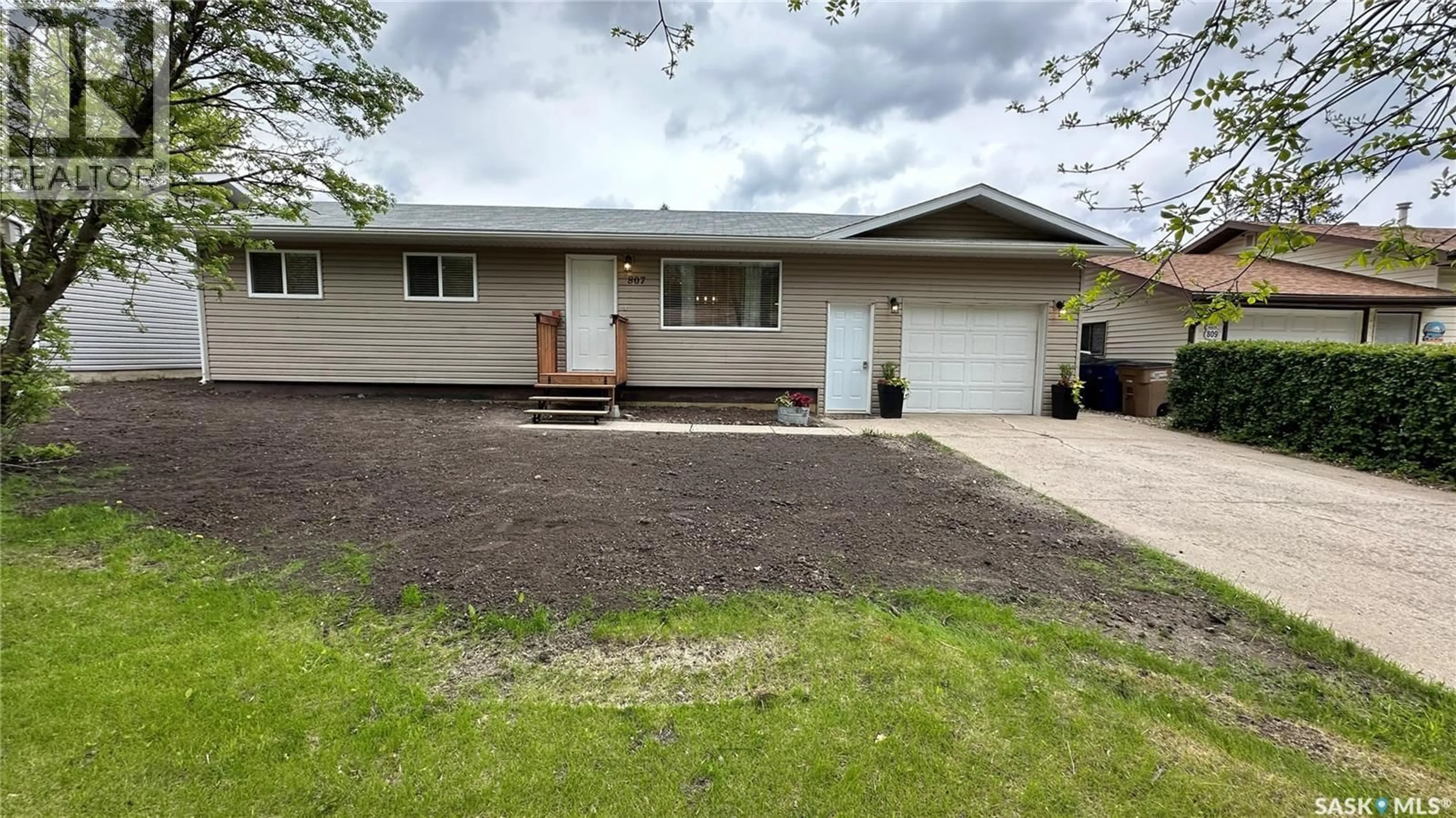 Home with vinyl exterior material, street for 807 107TH AVENUE, Tisdale Saskatchewan S0E1T0