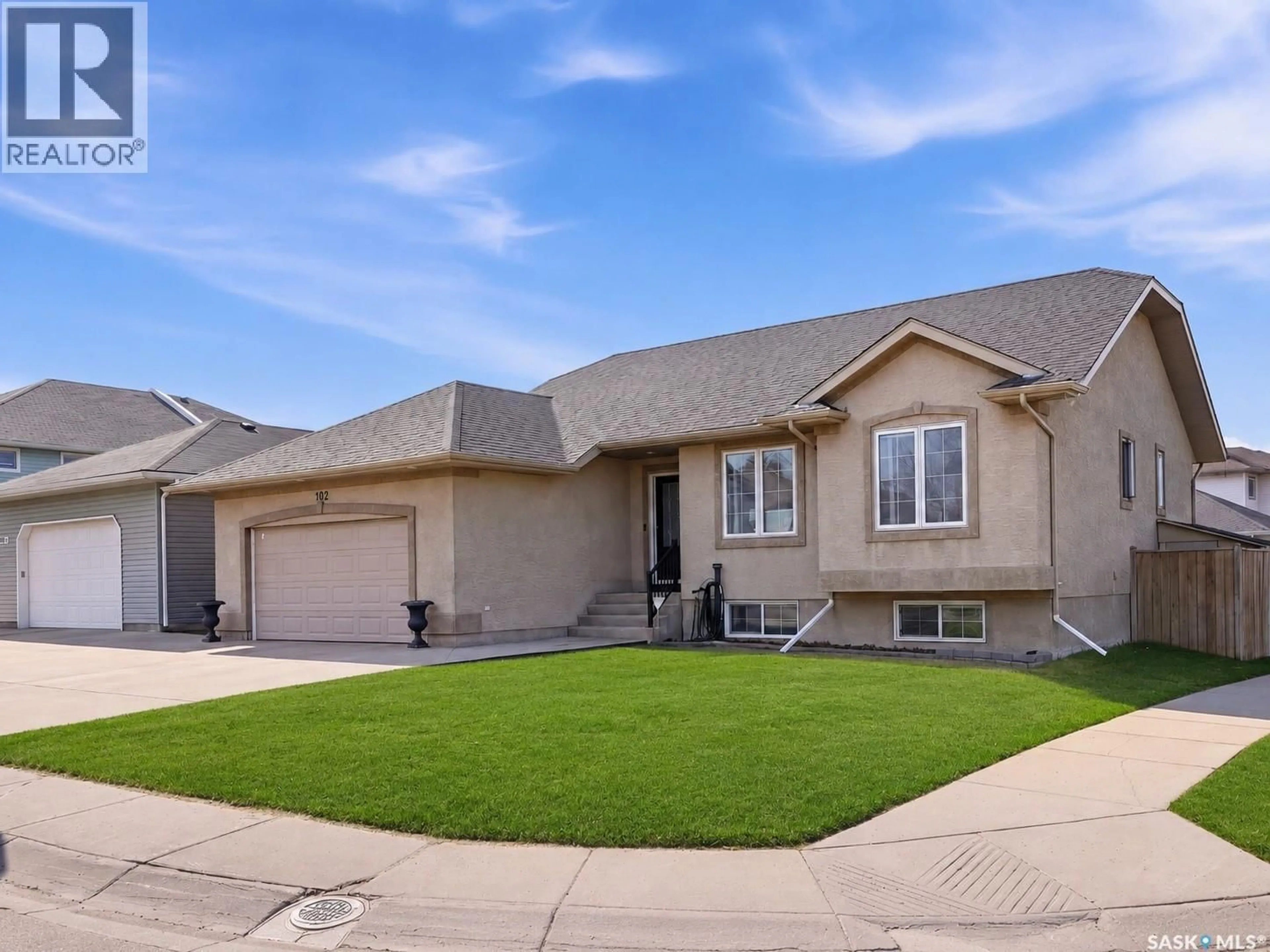 Home with vinyl exterior material, street for 102 KEEDWELL STREET, Saskatoon Saskatchewan S7W1B4