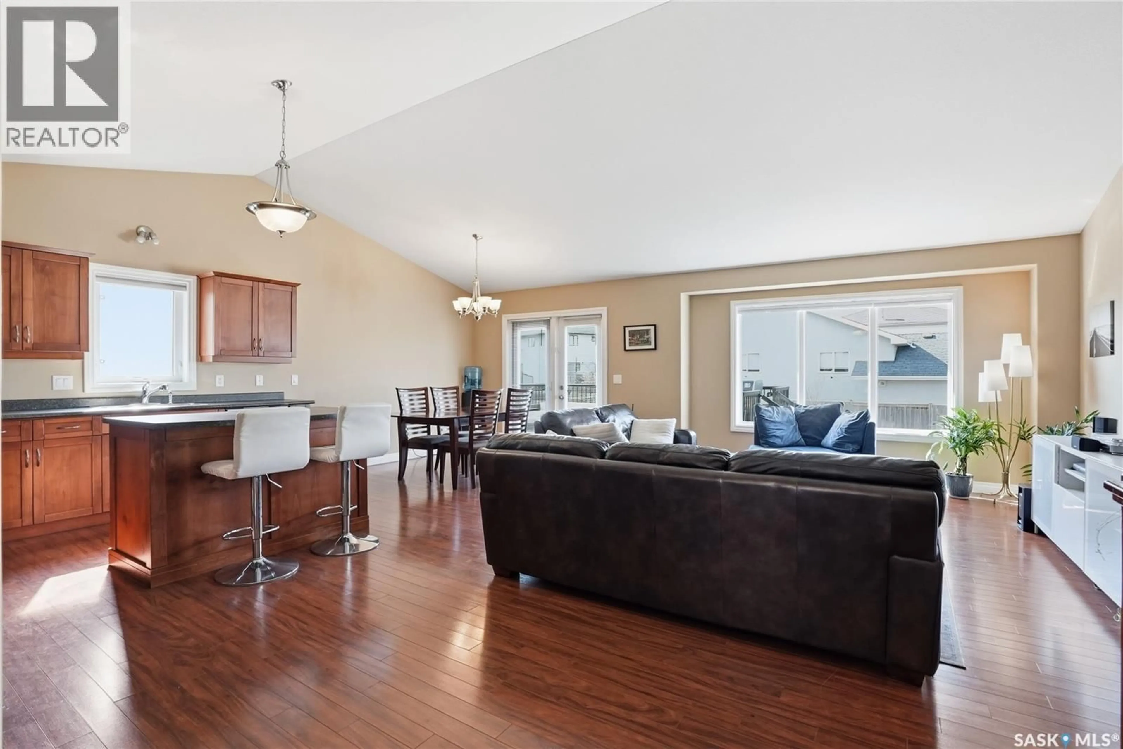 Living room with furniture, wood/laminate floor for 102 KEEDWELL STREET, Saskatoon Saskatchewan S7W1B4