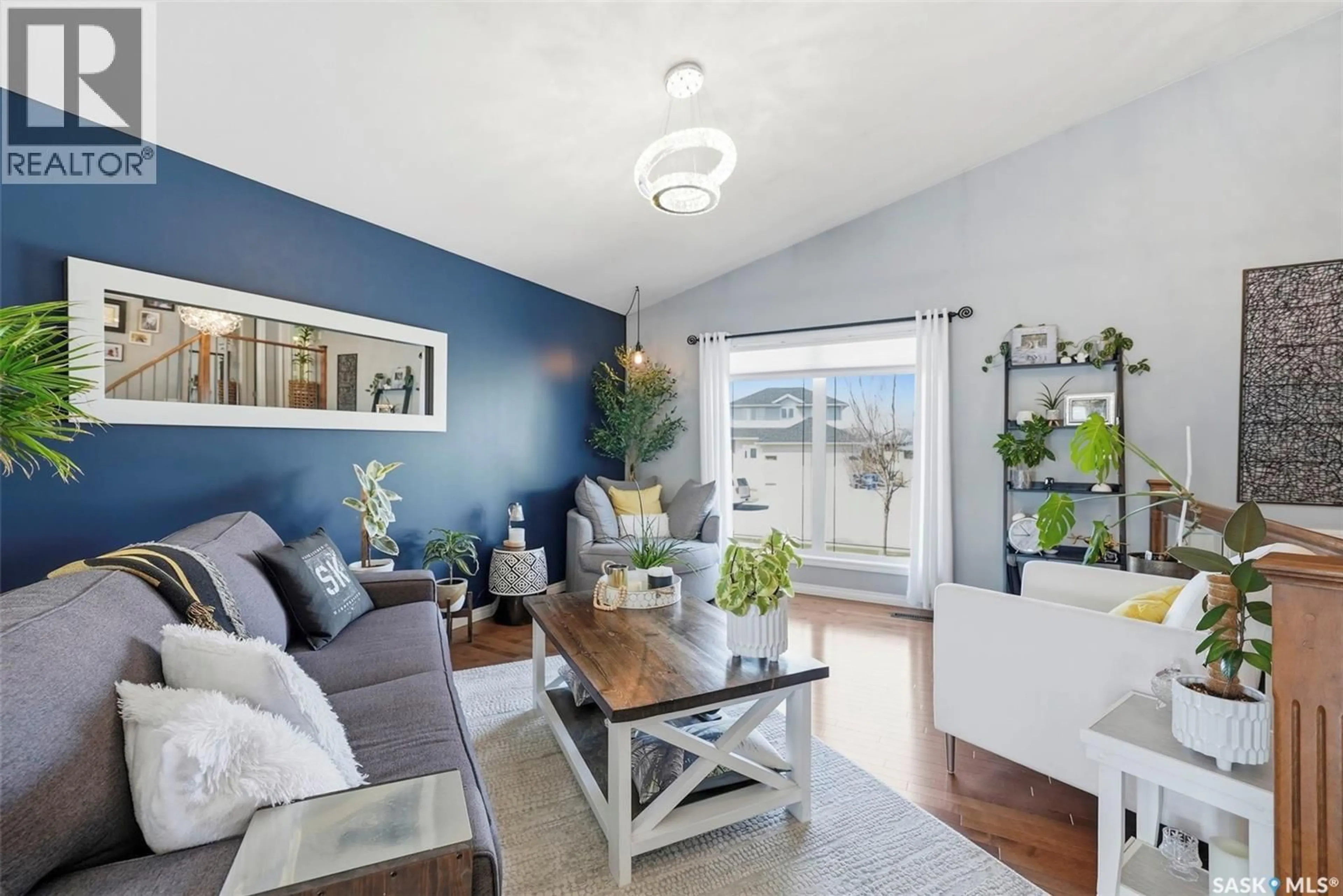 Living room with furniture, wood/laminate floor for 139 ALLWOOD CRESCENT, Saskatoon Saskatchewan S7R0A3