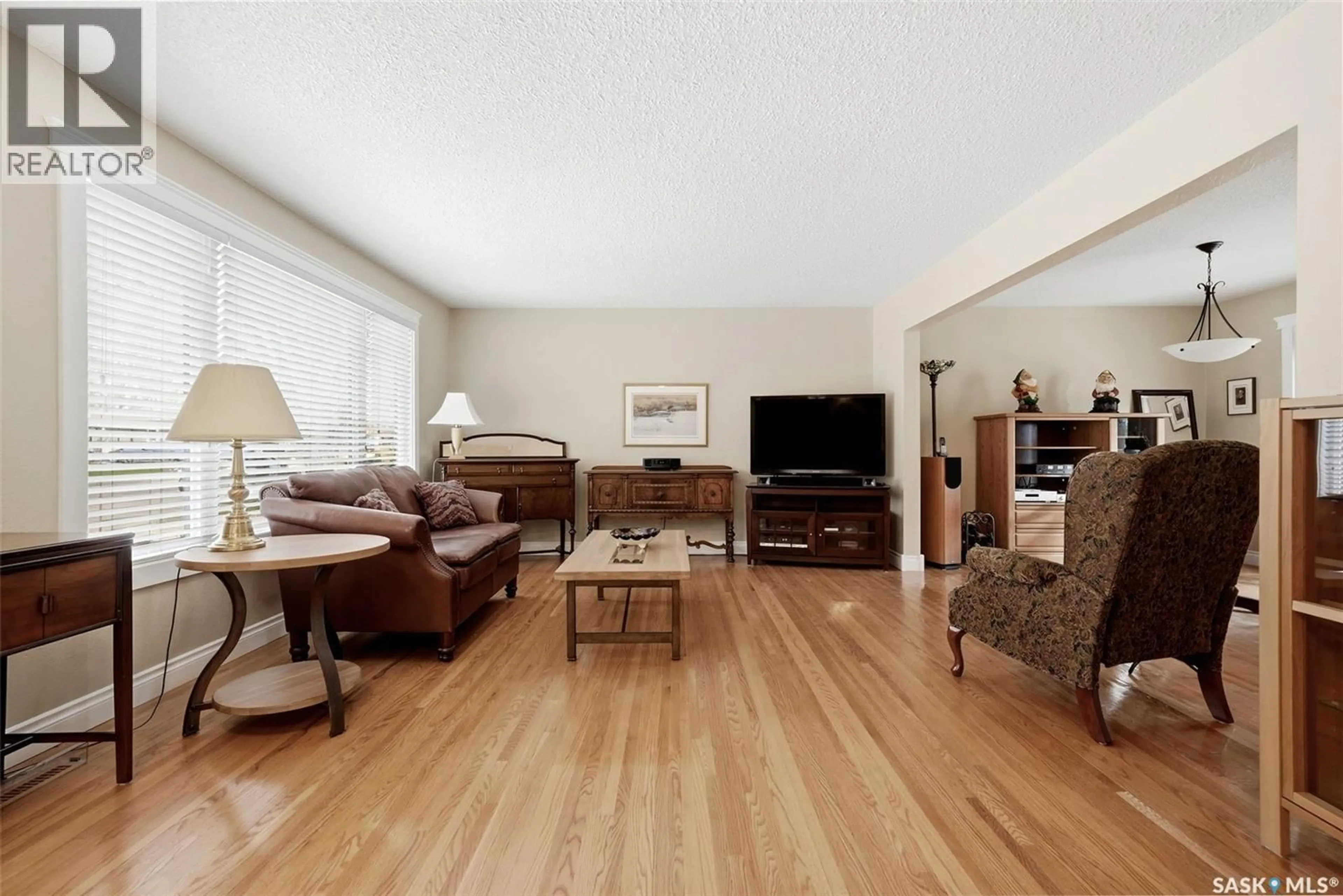 Living room with furniture, wood/laminate floor for 229 20TH AVENUE, Regina Saskatchewan S4N1J5