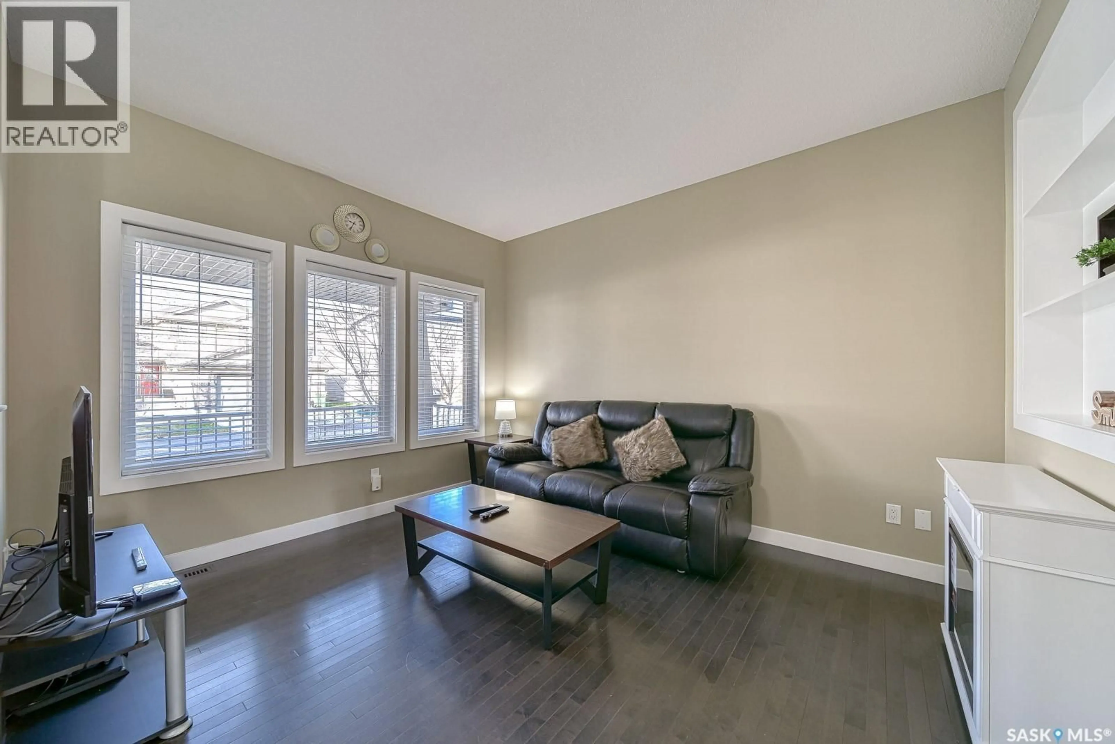 Living room with furniture, wood/laminate floor for 3366 GREEN MOSS LANE, Regina Saskatchewan S4V1P2