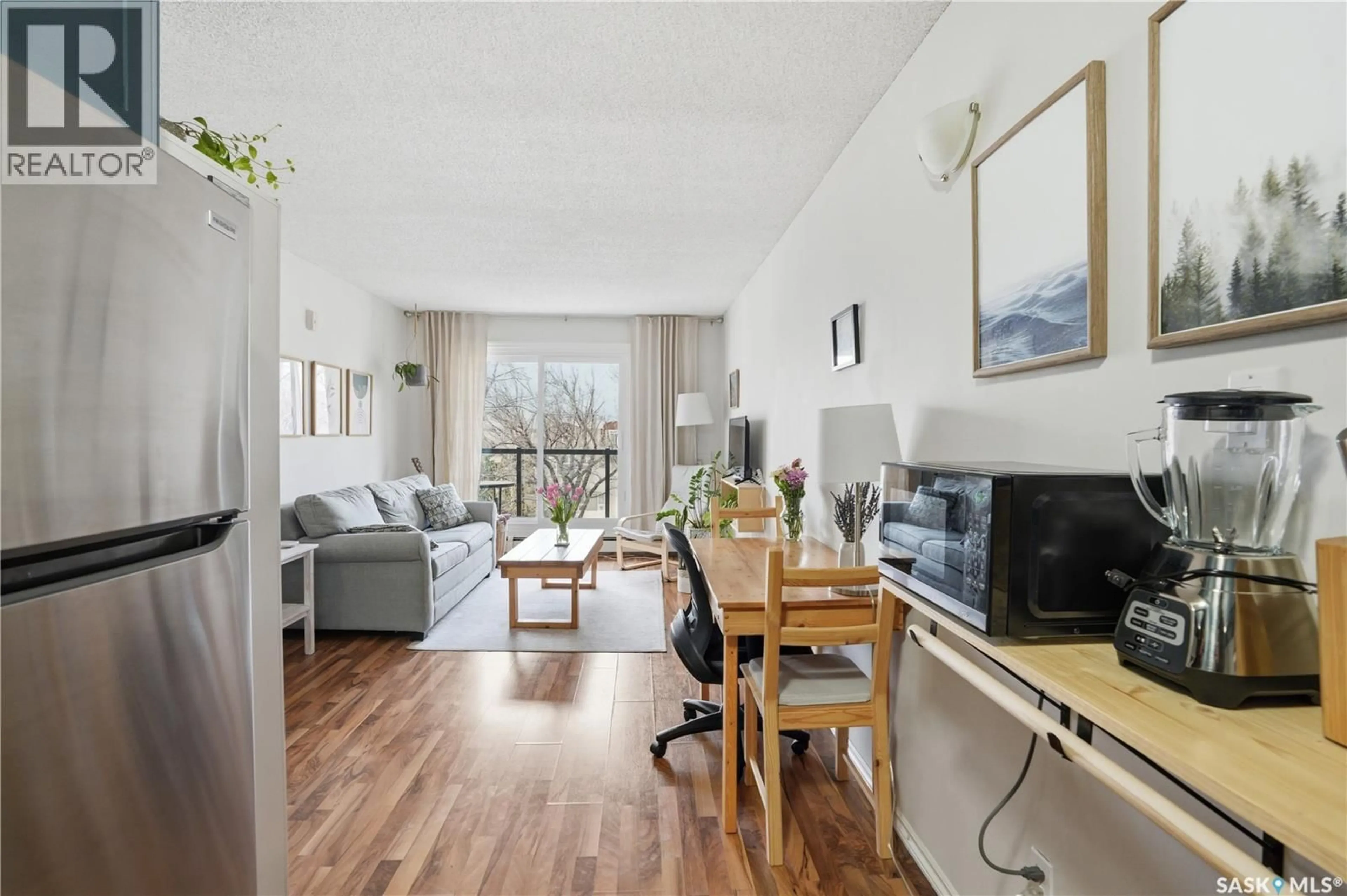 Living room with furniture, wood/laminate floor for 403 - 1013 LANSDOWNE AVENUE, Saskatoon Saskatchewan S7H2C2