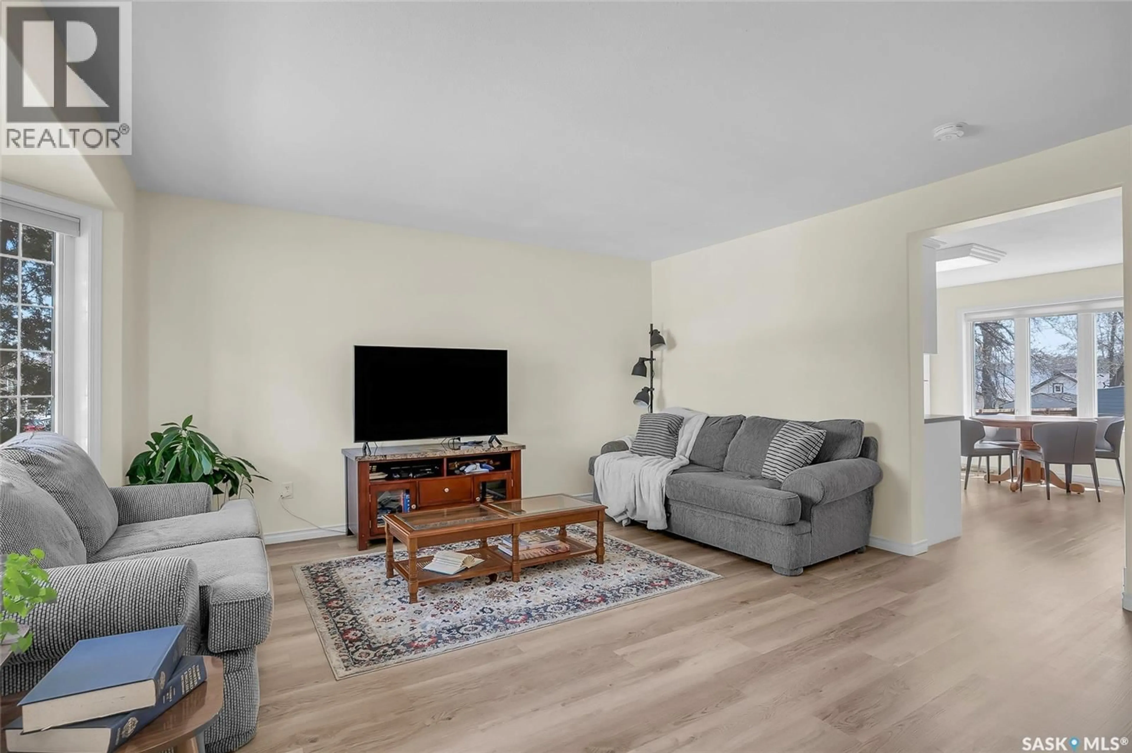 Living room with furniture, wood/laminate floor for 1122 12TH STREET, Saskatoon Saskatchewan S7H0E2