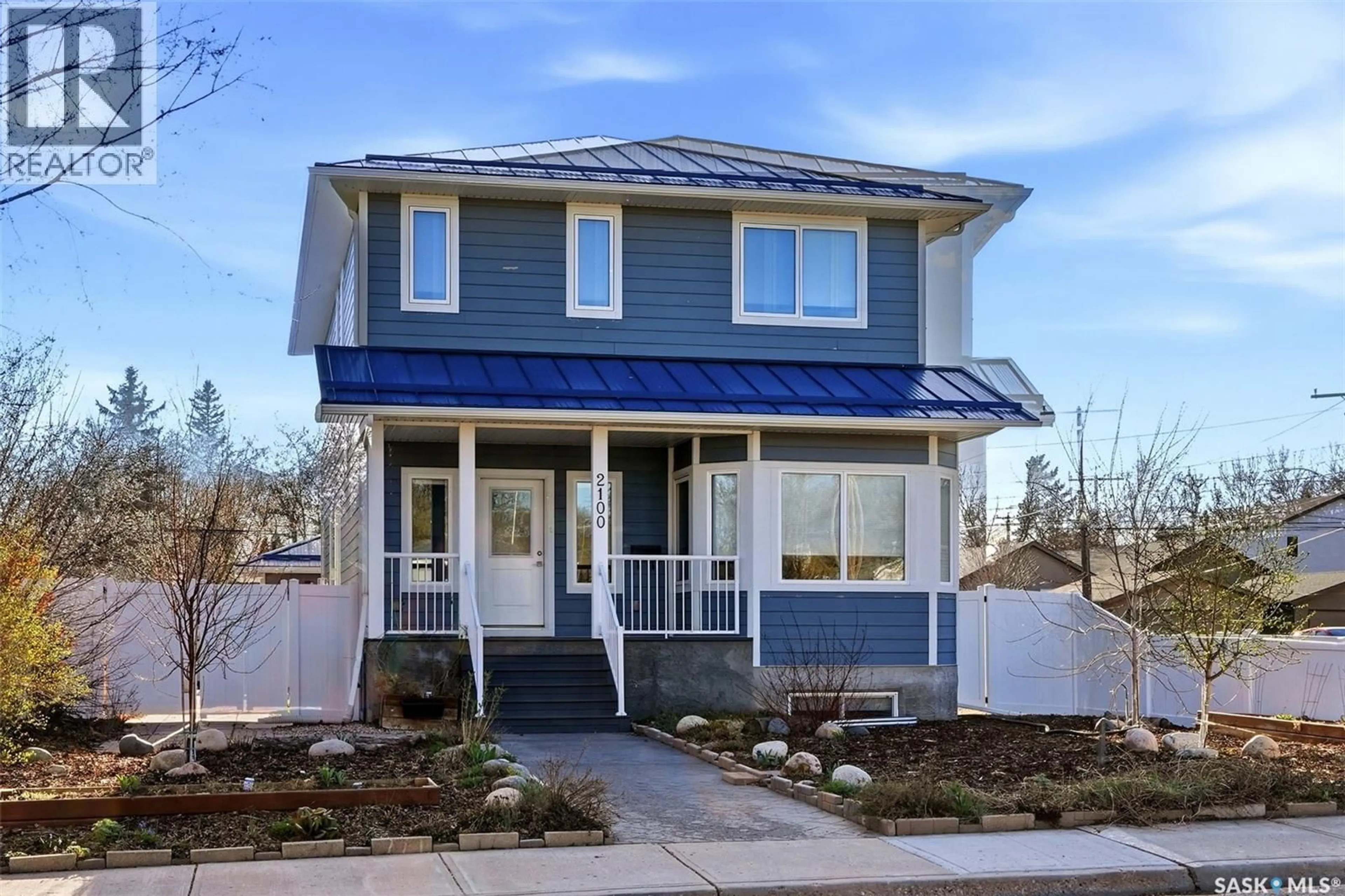 Home with vinyl exterior material, street for 2100 QUEEN STREET, Regina Saskatchewan S4T4C3