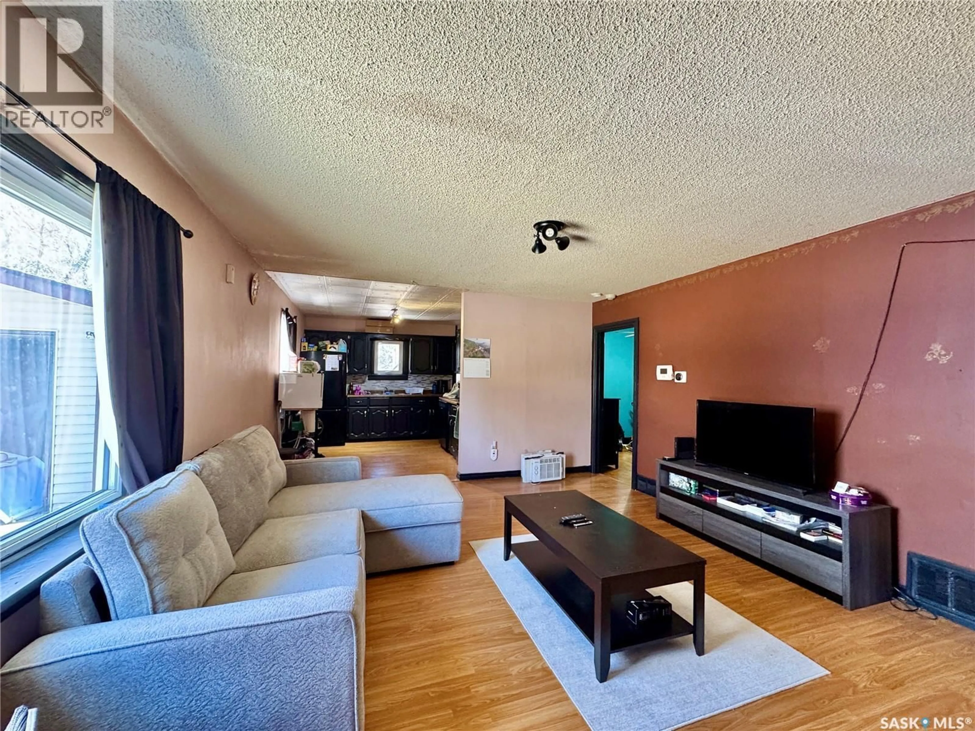 Living room with furniture, wood/laminate floor for 310 4TH STREET, Bredenbury Saskatchewan S0A0H0