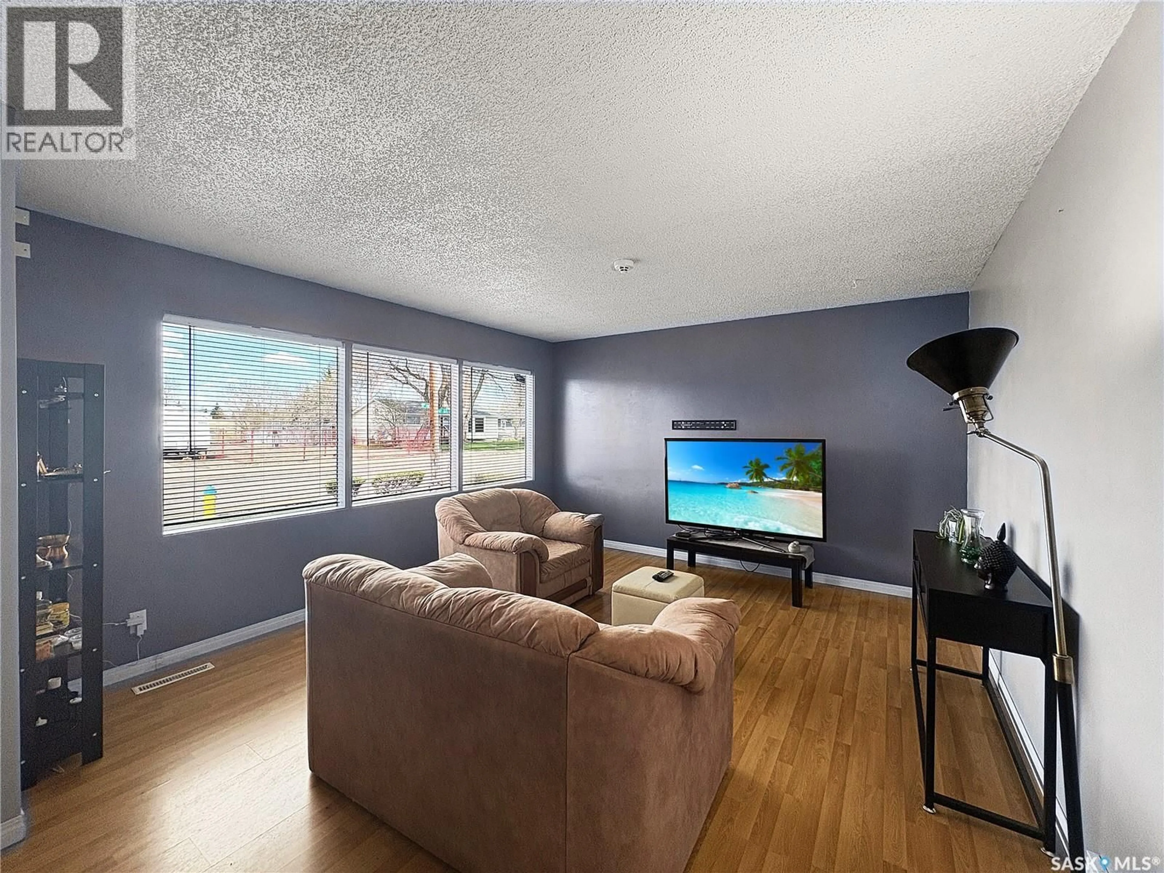 Living room with furniture, wood/laminate floor for 1762 91ST STREET, North Battleford Saskatchewan S9A0A5