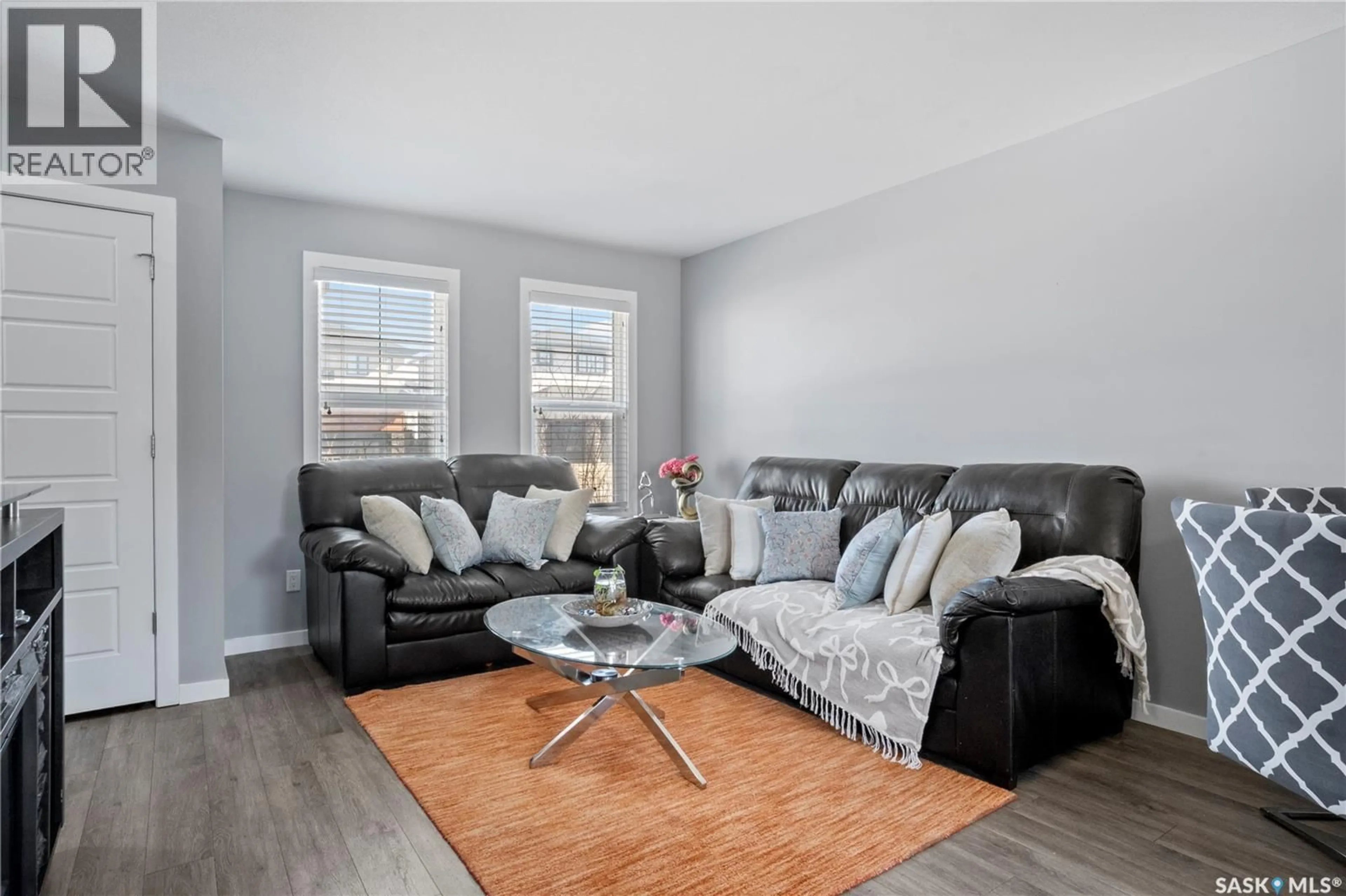Living room with furniture, wood/laminate floor for E - 4733 PRIMROSE GREEN DRIVE, Regina Saskatchewan S4V3K9