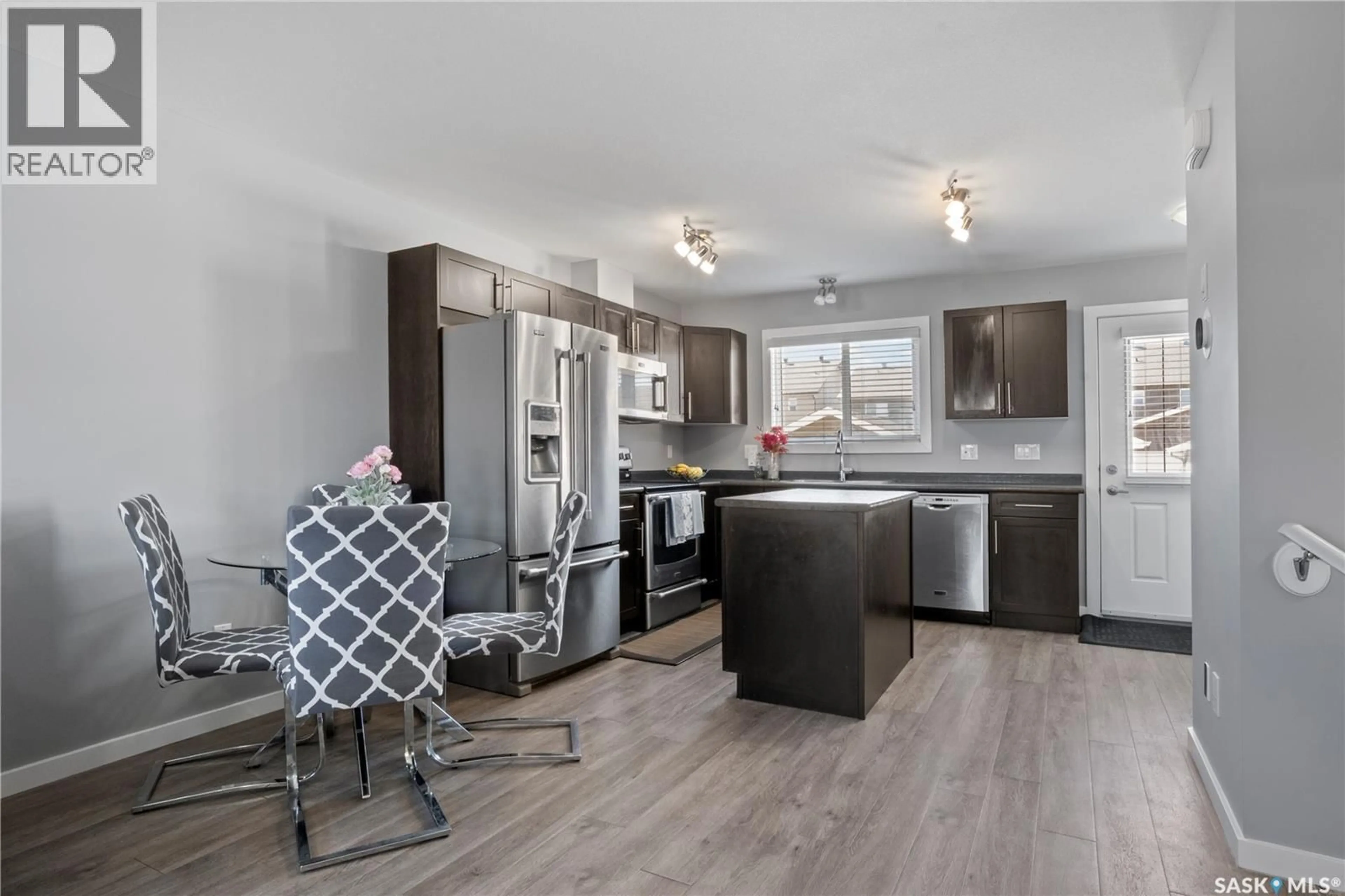 Open concept kitchen, wood/laminate floor for E - 4733 PRIMROSE GREEN DRIVE, Regina Saskatchewan S4V3K9
